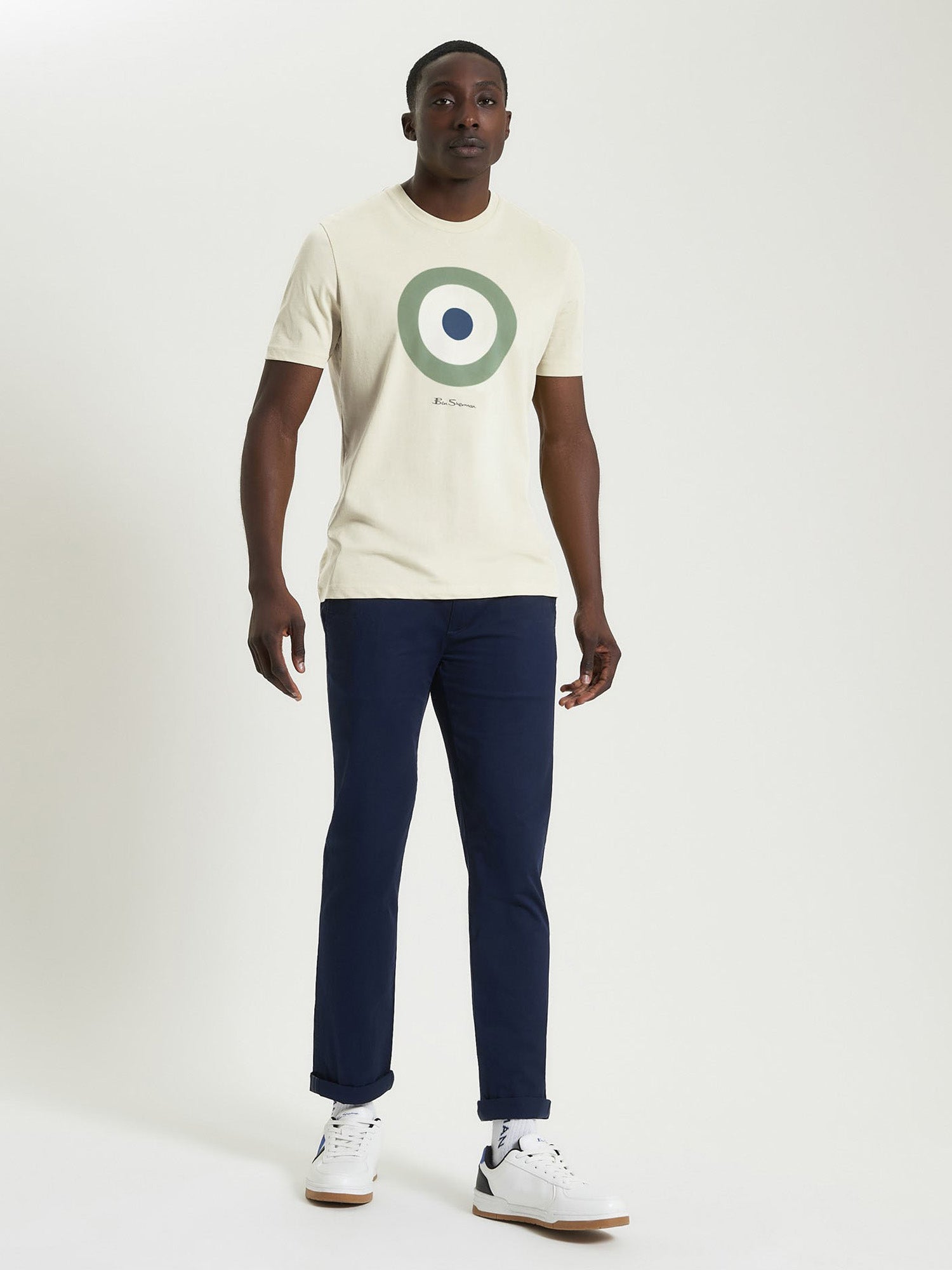 Signature Target Tee – Crew Neck Regular Fit with Target Print in Beige worn with navy pants and white sneakers.