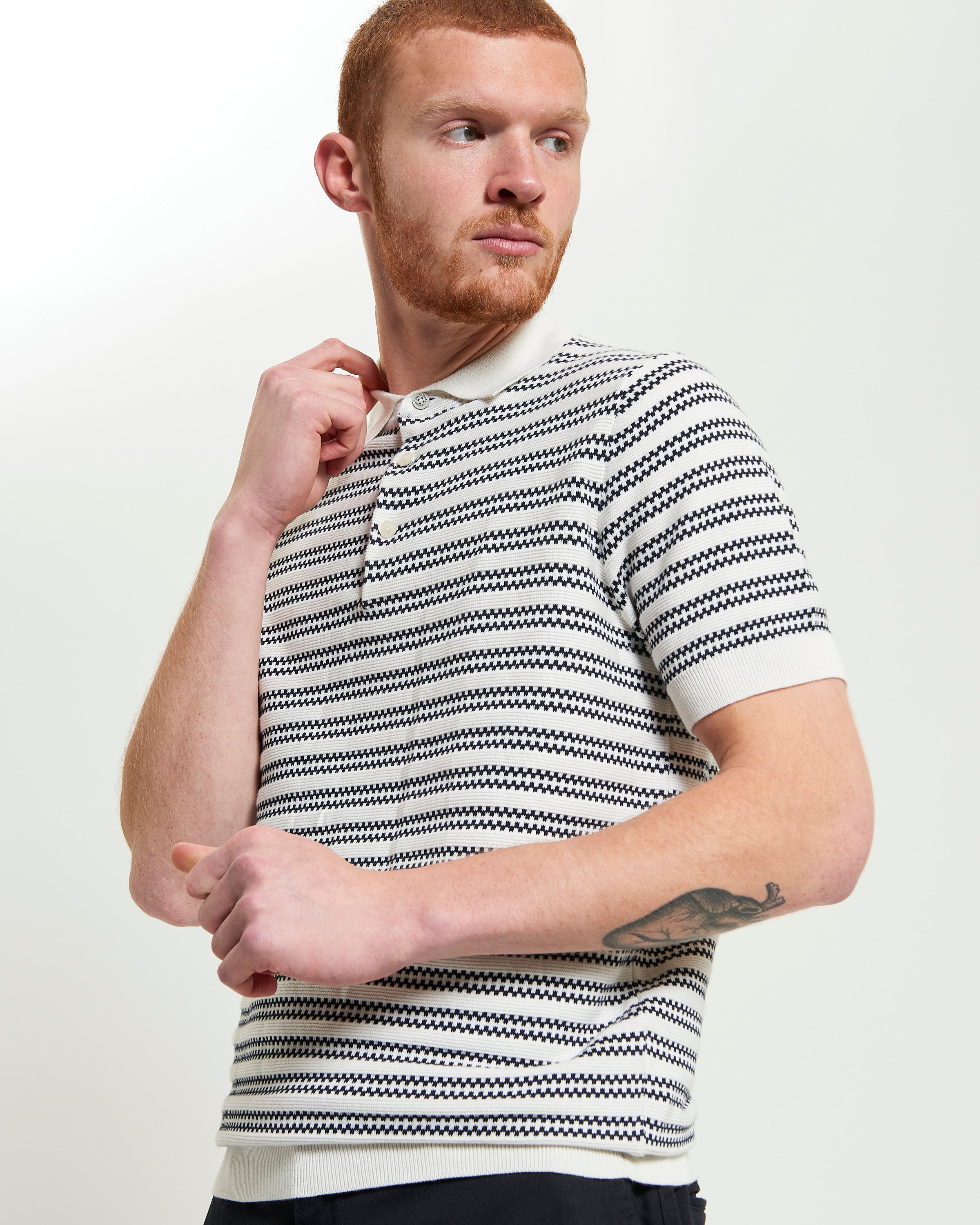 Jacquard Stripe Polo – short-sleeve knit featuring intricate stripe jacquard pattern and ribbed collar.