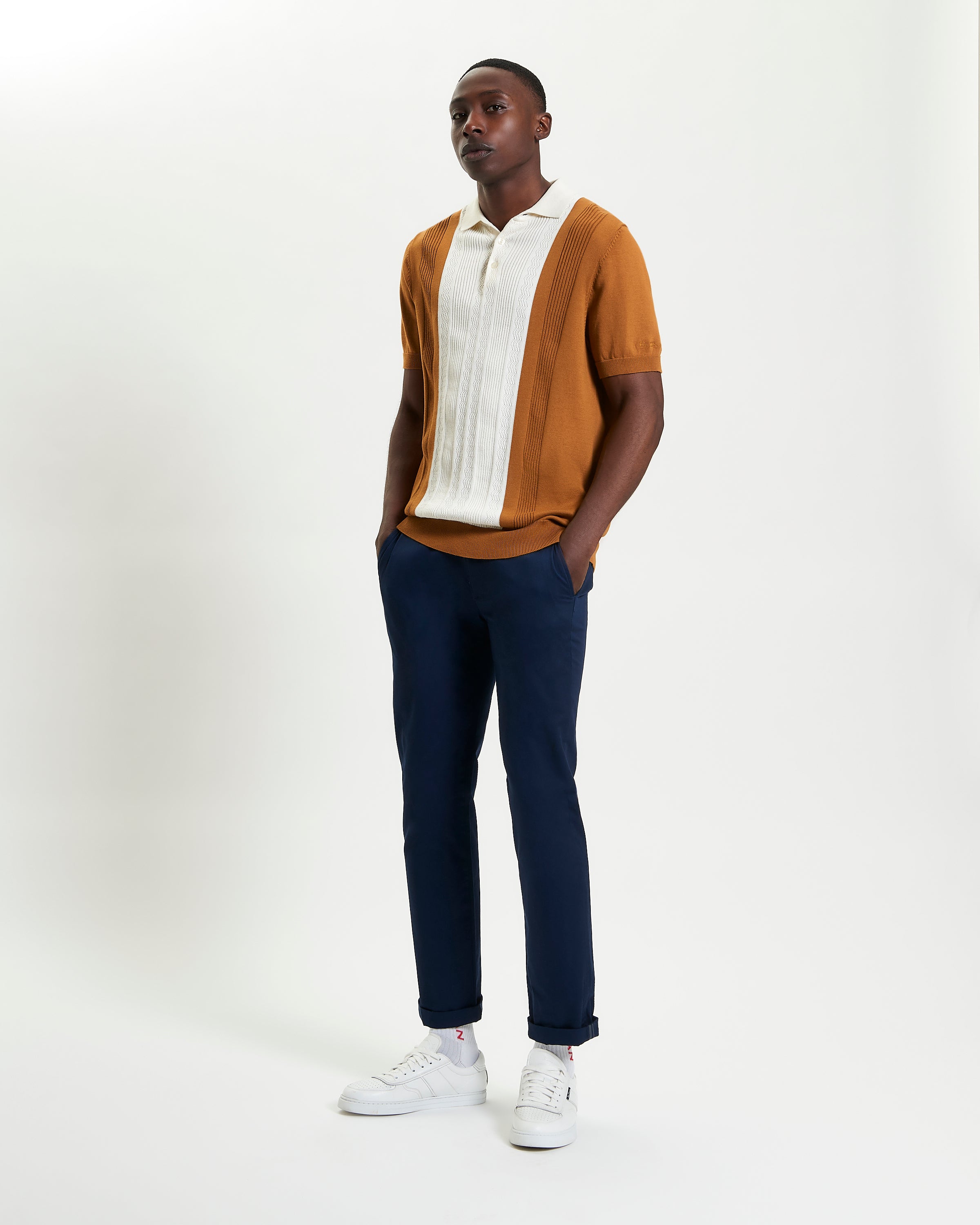Textured Block Stripe Polo – brown and white short sleeve polo on model with navy pants and sneakers.