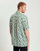 Carnaby Geo Print – Short sleeve shirt with revere collar and green geometric pattern.
