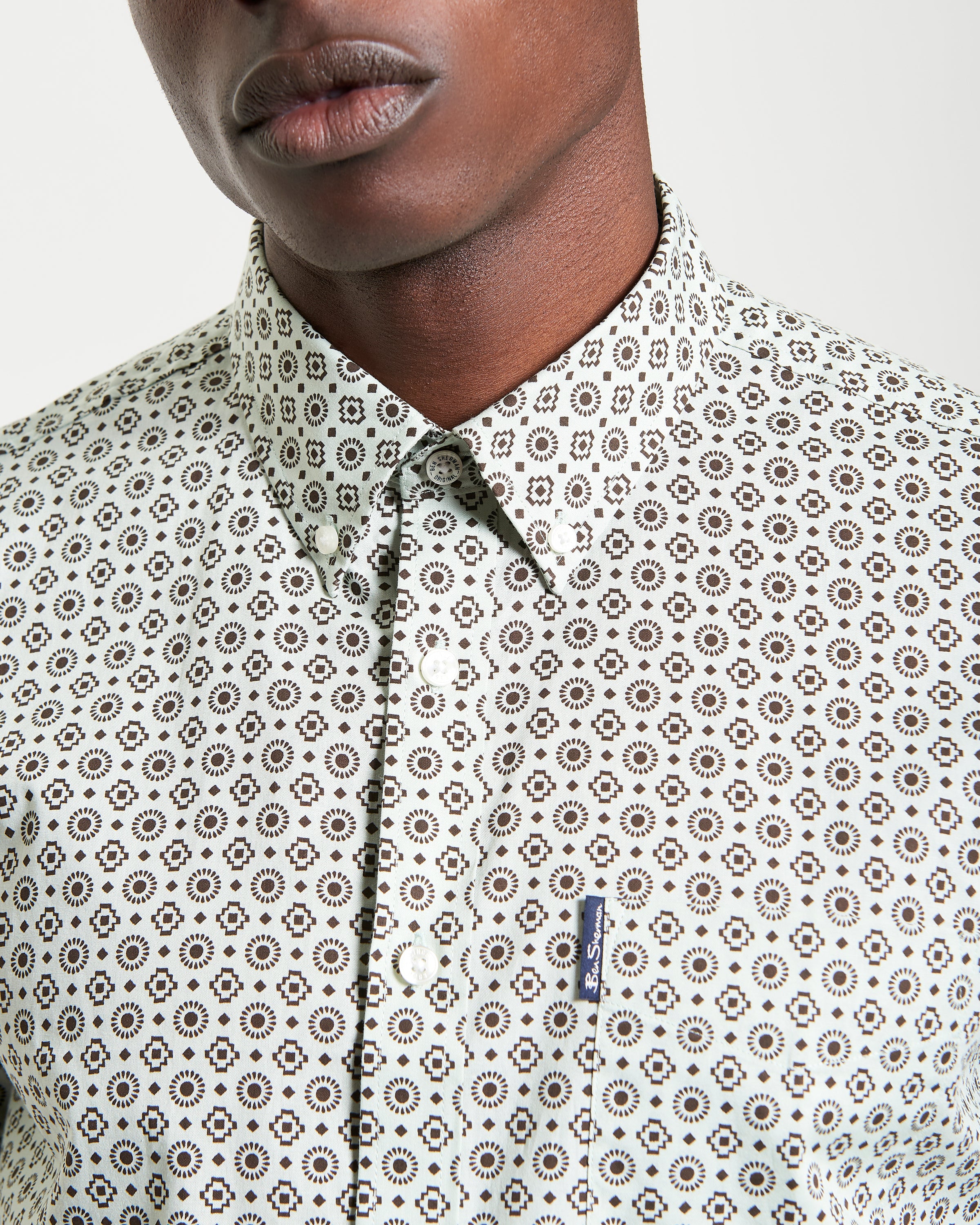 Block Geo Print short sleeve shirt close-up featuring button-down collar and curved hem.