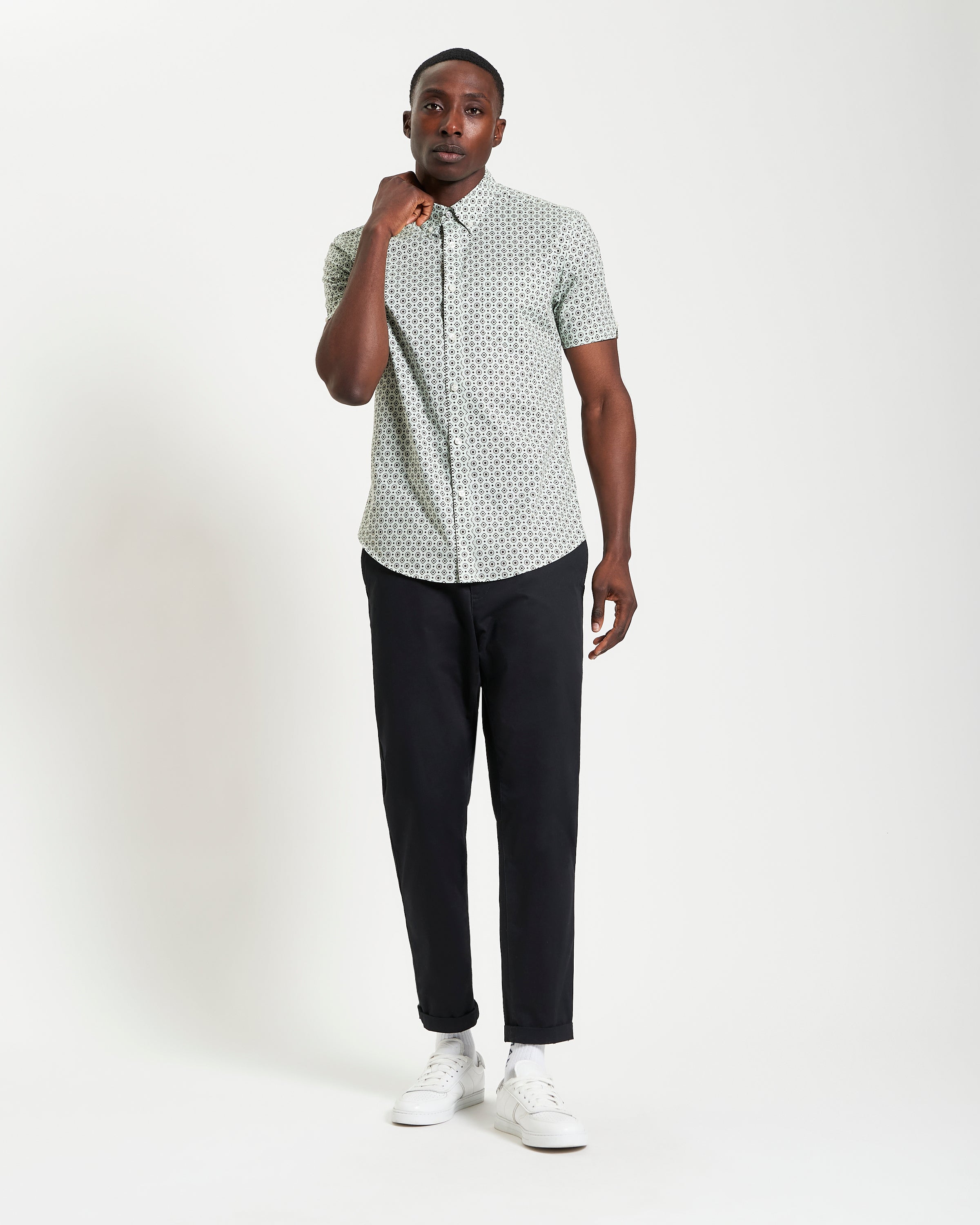 Model showcasing the Block Geo Print short sleeve shirt with stylish pants, exuding a trendy and comfortable look.