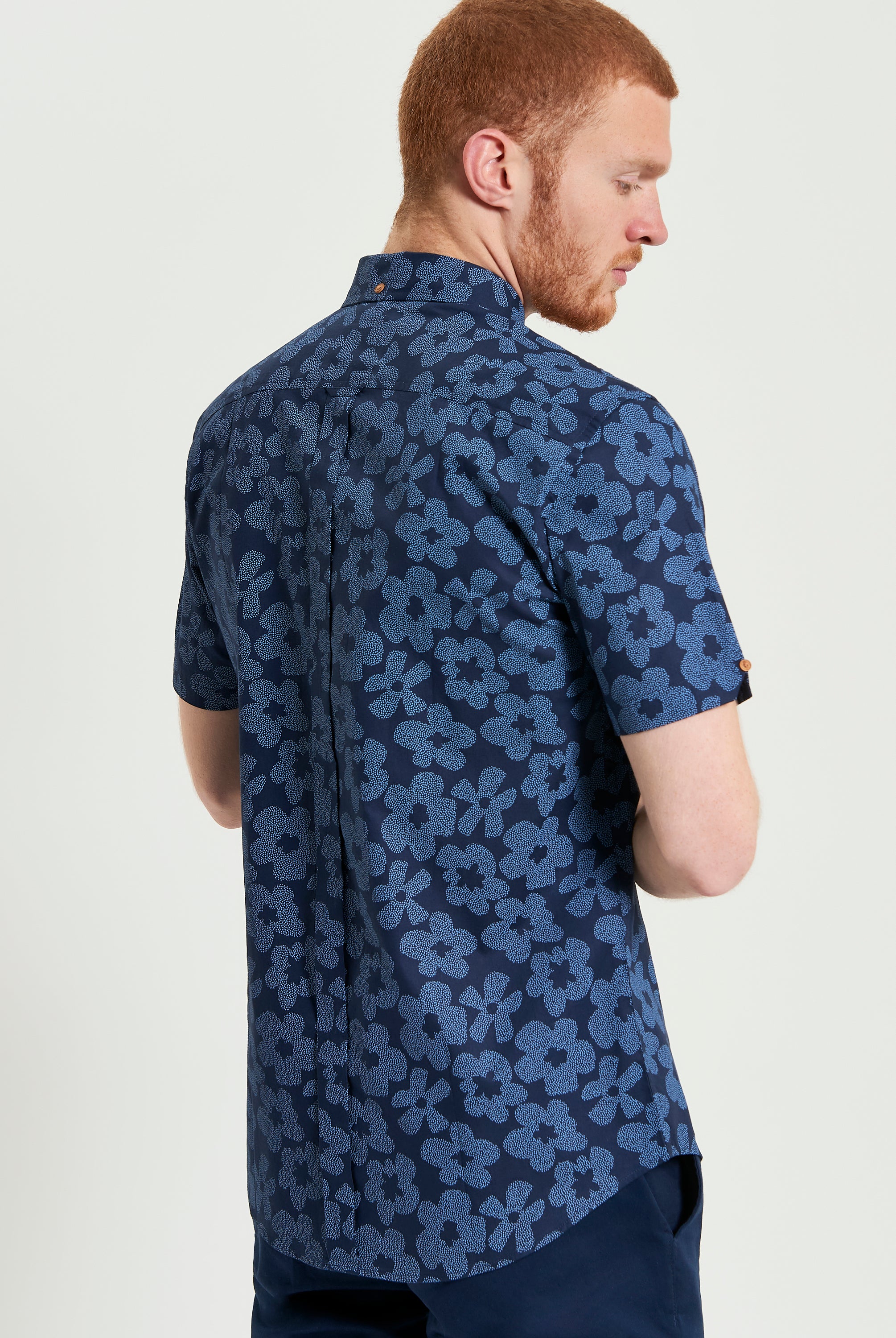 Stipple Floral Print shirt showcasing a blue floral design with short sleeves and tailored fit, perfect for smart-casual settings.