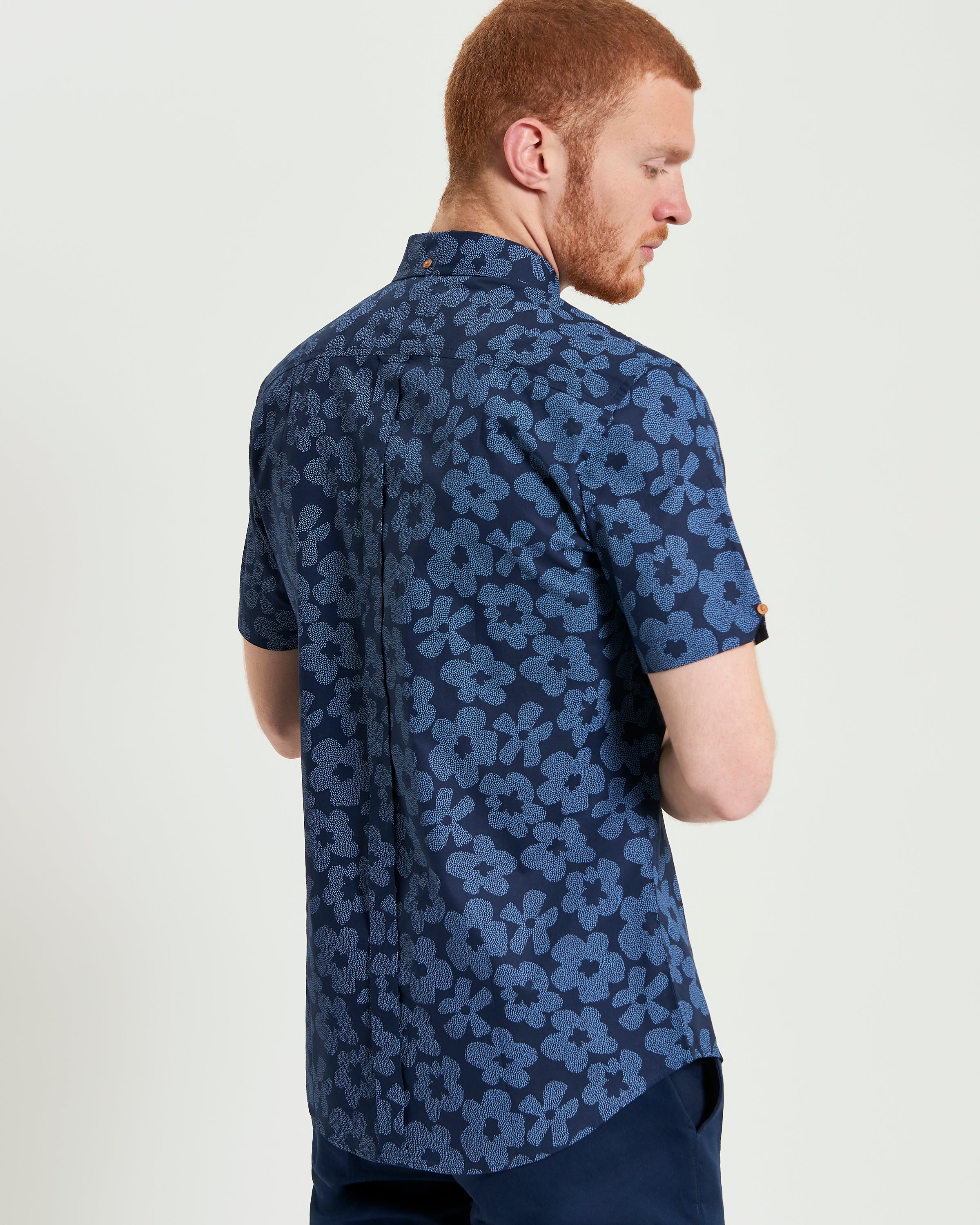 Stipple Floral Print shirt showcasing a blue floral design with short sleeves and tailored fit, perfect for smart-casual settings.