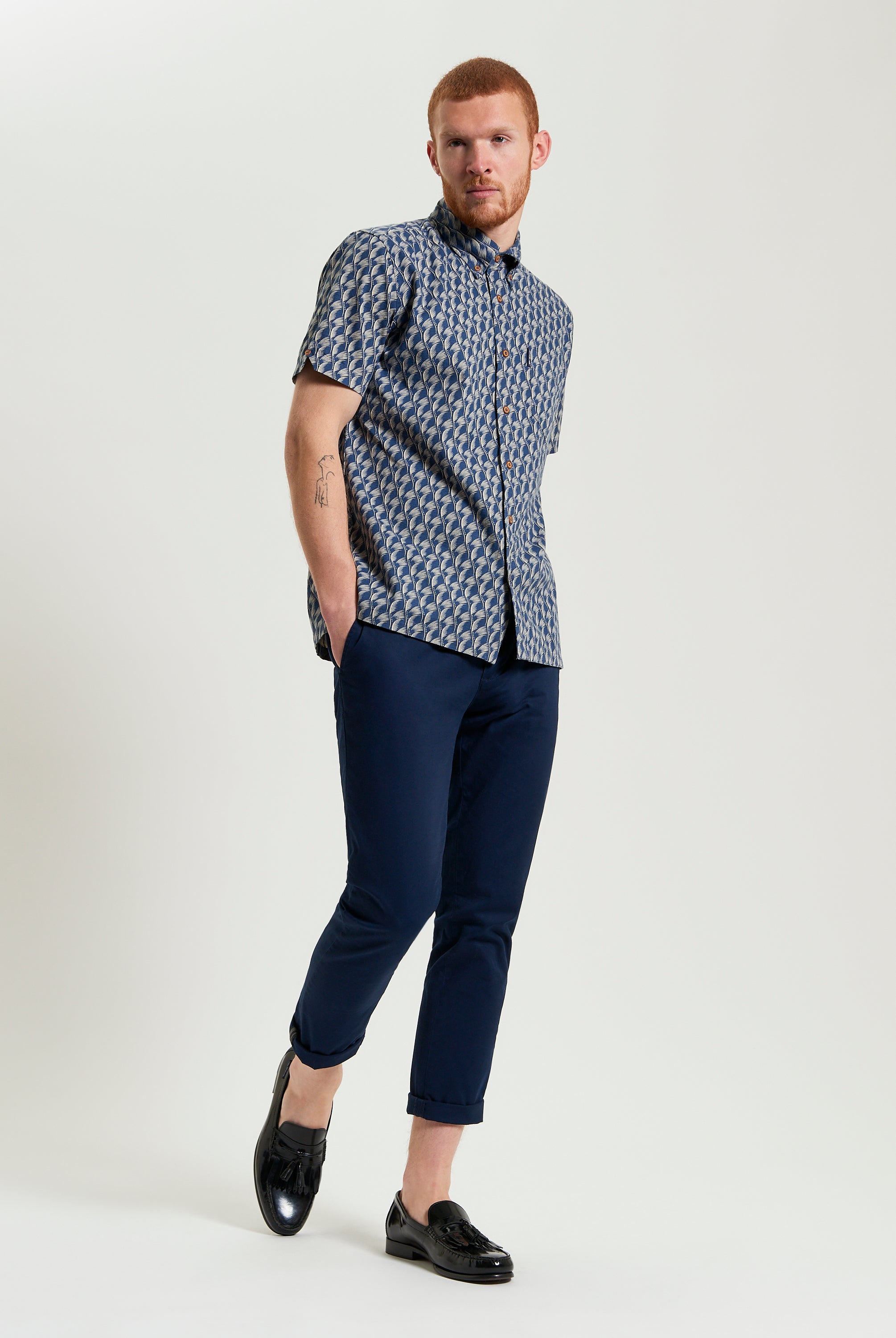 Block Leaf Print Shirt on a model styled with navy pants and black shoes, showcasing a nature-inspired pattern.