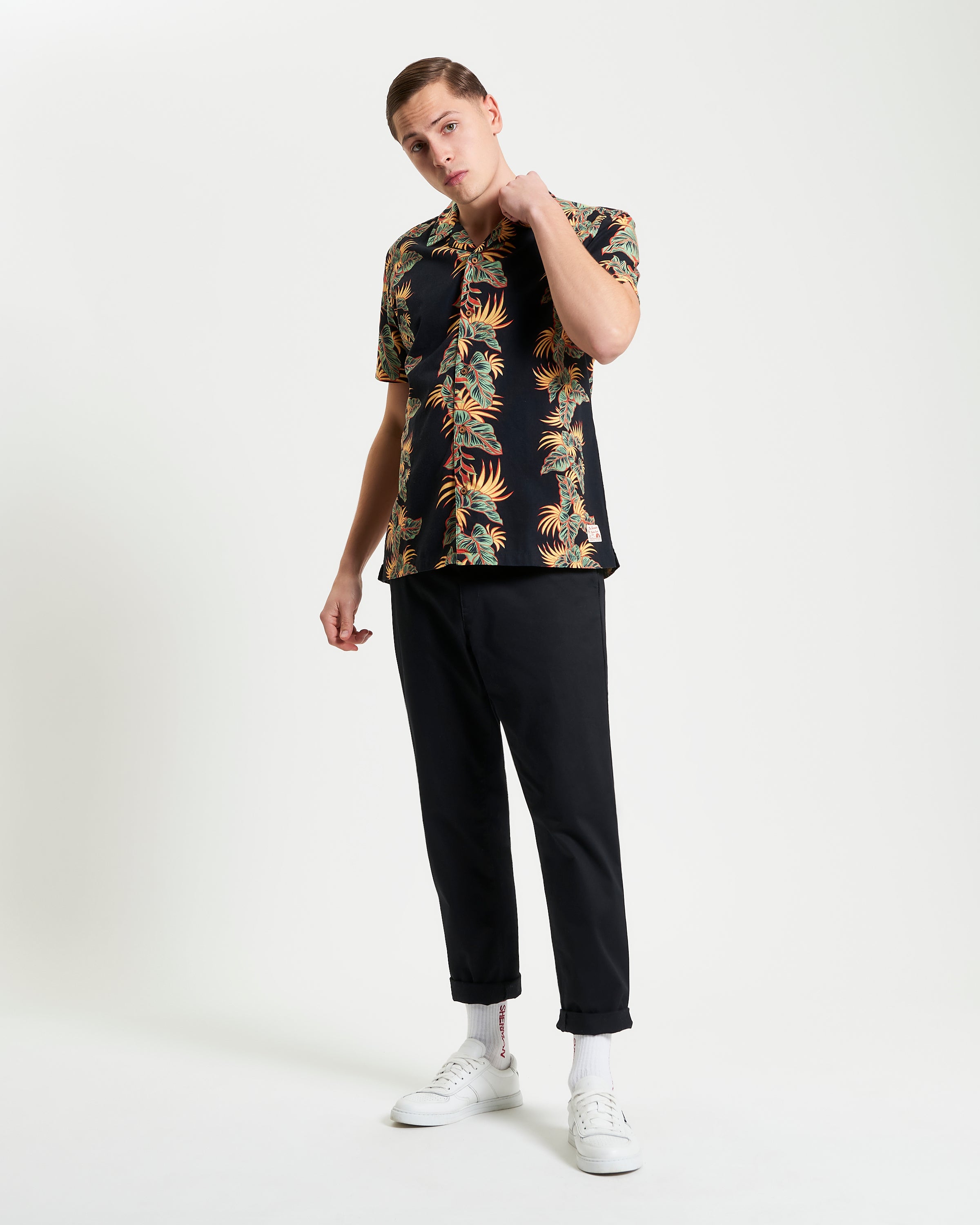 Botanical Leaf Print short sleeve shirt styled casually with black pants and white sneakers, perfect for summer.