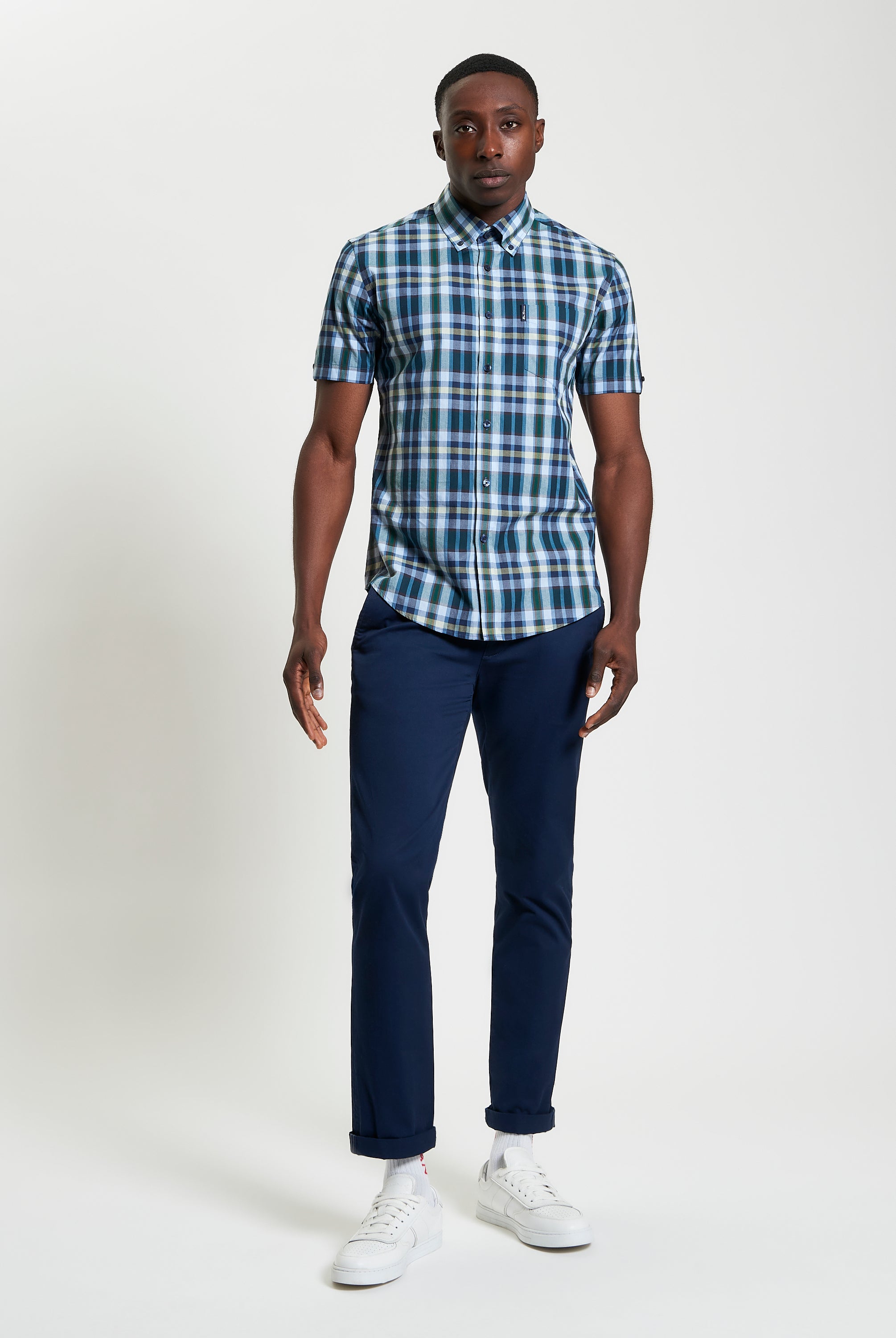 Irregular Check – blue and green short sleeve shirt worn with navy pants and white sneakers.