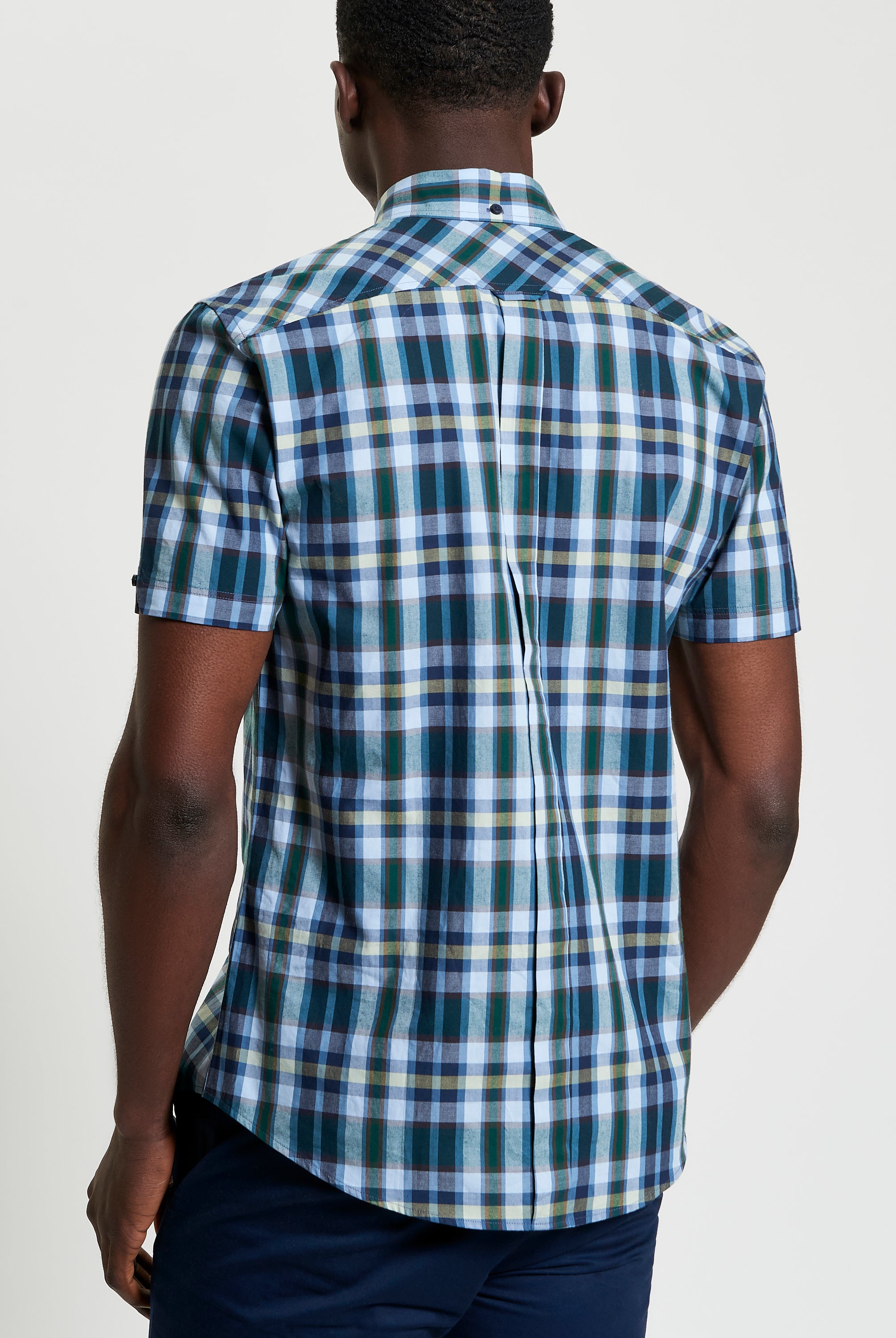 Irregular Check shirt – back view showcasing modern check pattern and curved hem design.