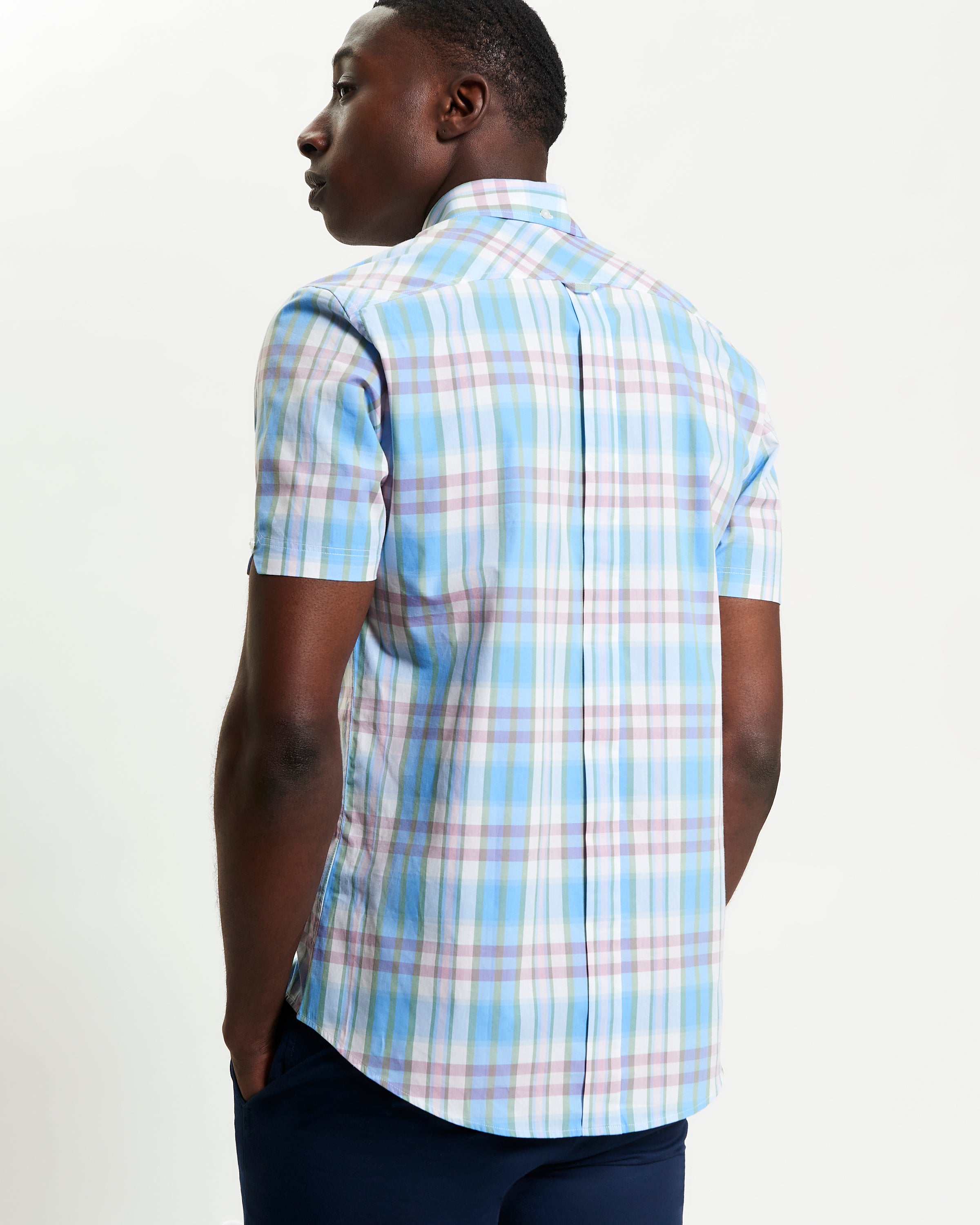 Irregular Check shirt shown from the back, featuring a blue and pastel plaid design with a curved hem.