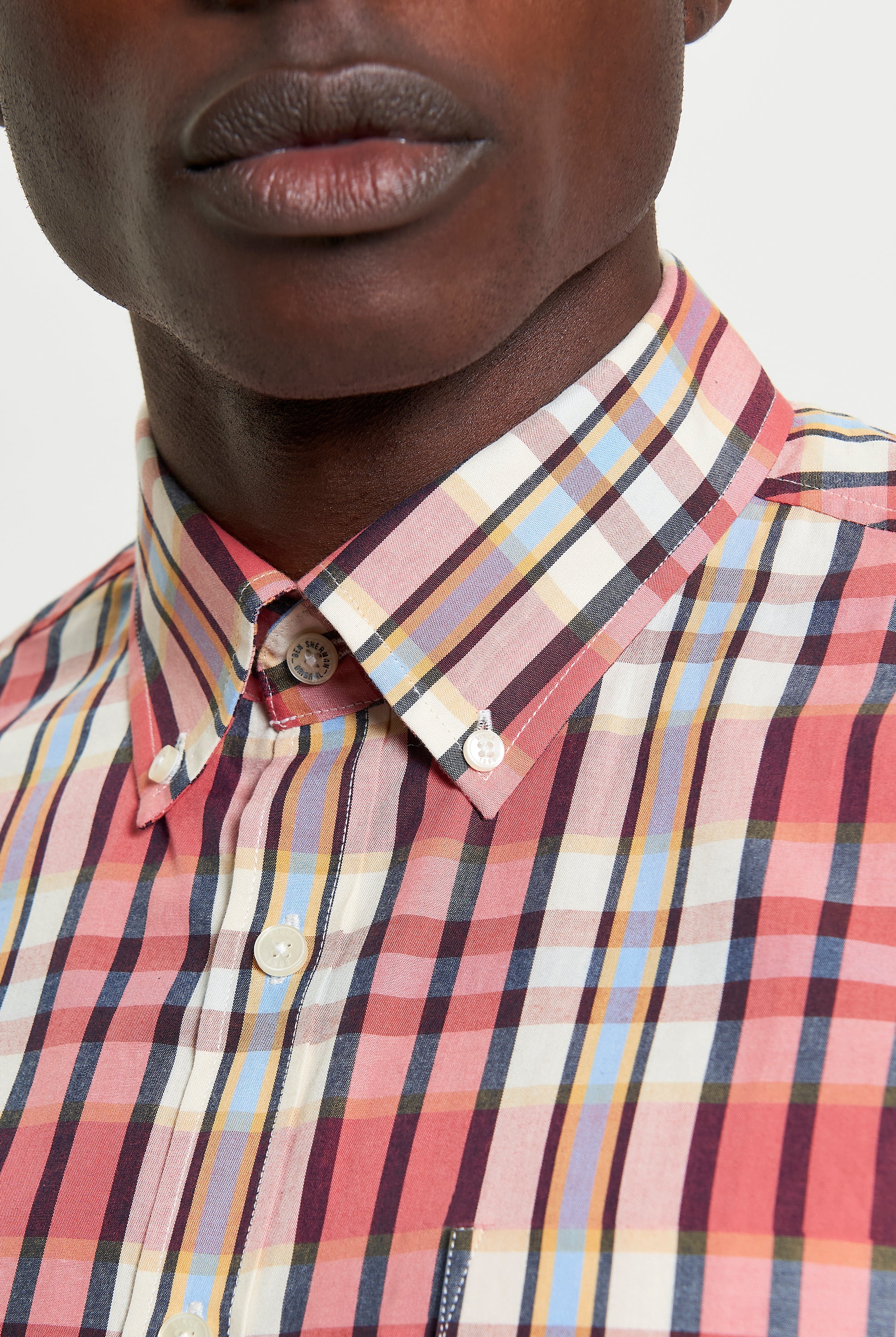 Irregular Check shirt – organic cotton with curved hem and button-down collar.
