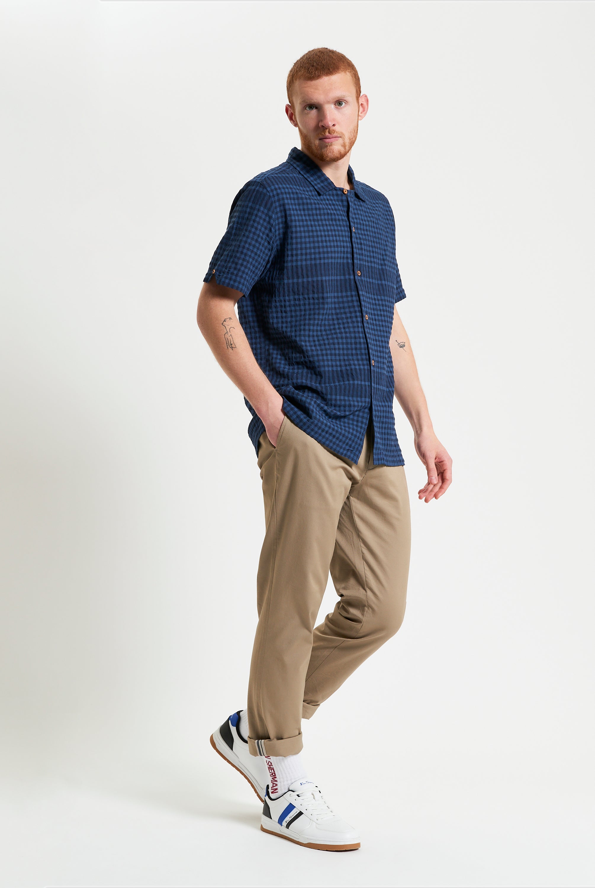 Seersucker Gingham short sleeve shirt worn with beige trousers and sneakers.