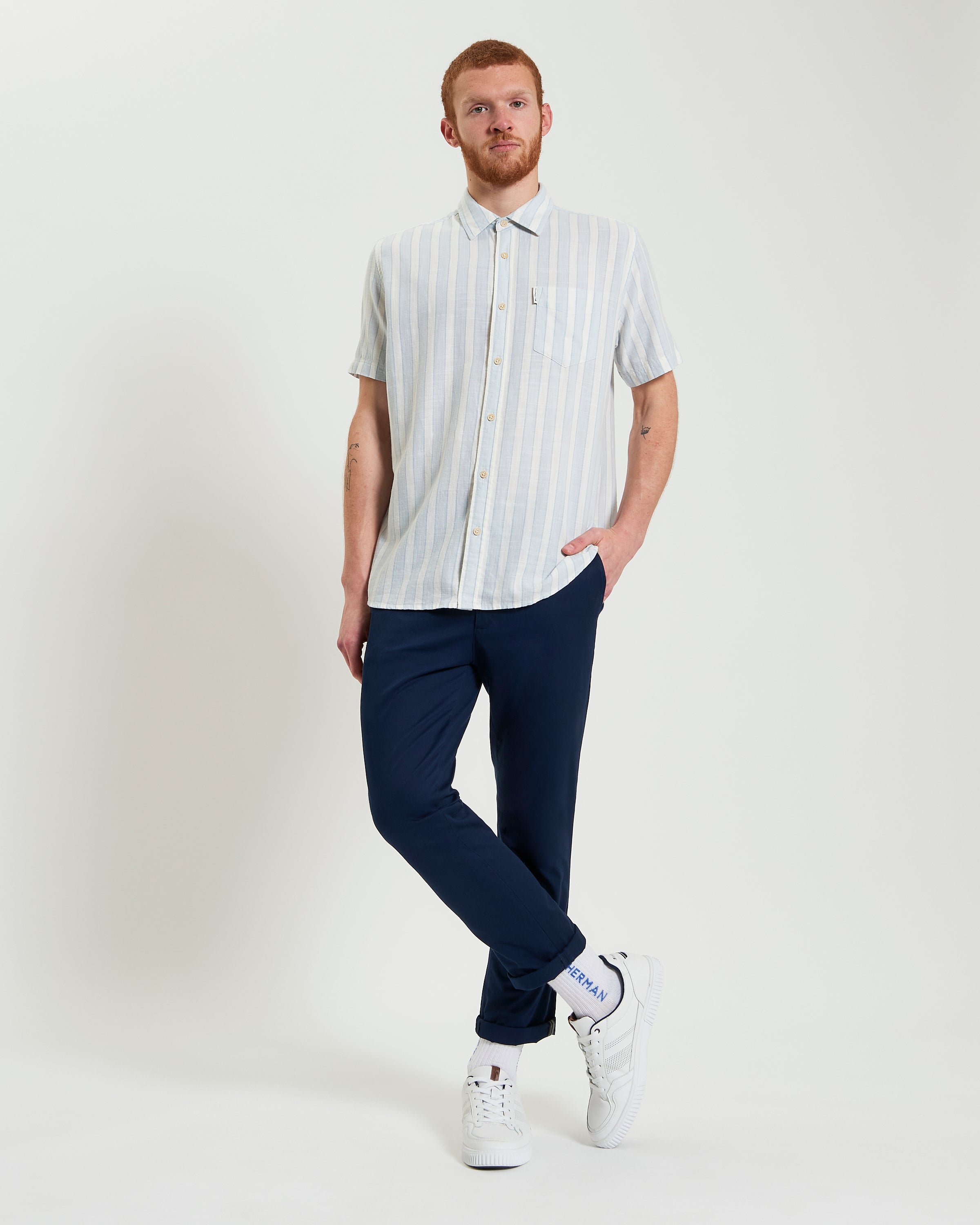 Framed Candy Stripe short sleeve shirt in light blue stripes paired with navy pants, perfect for a casual summer look.