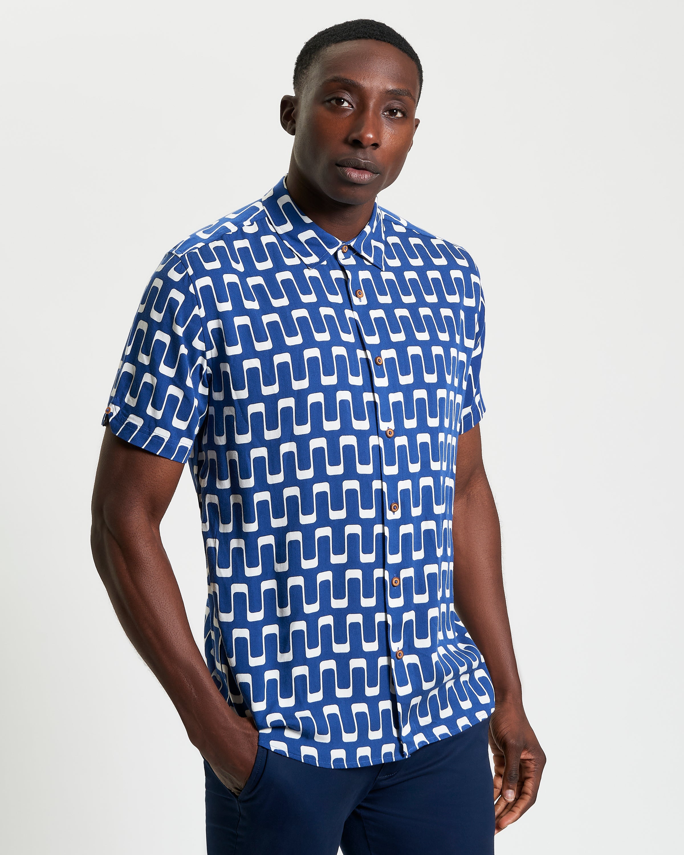 Jazz Print short sleeve shirt featuring an abstract wave motif in blue and white, perfect for warm days and evening outings.