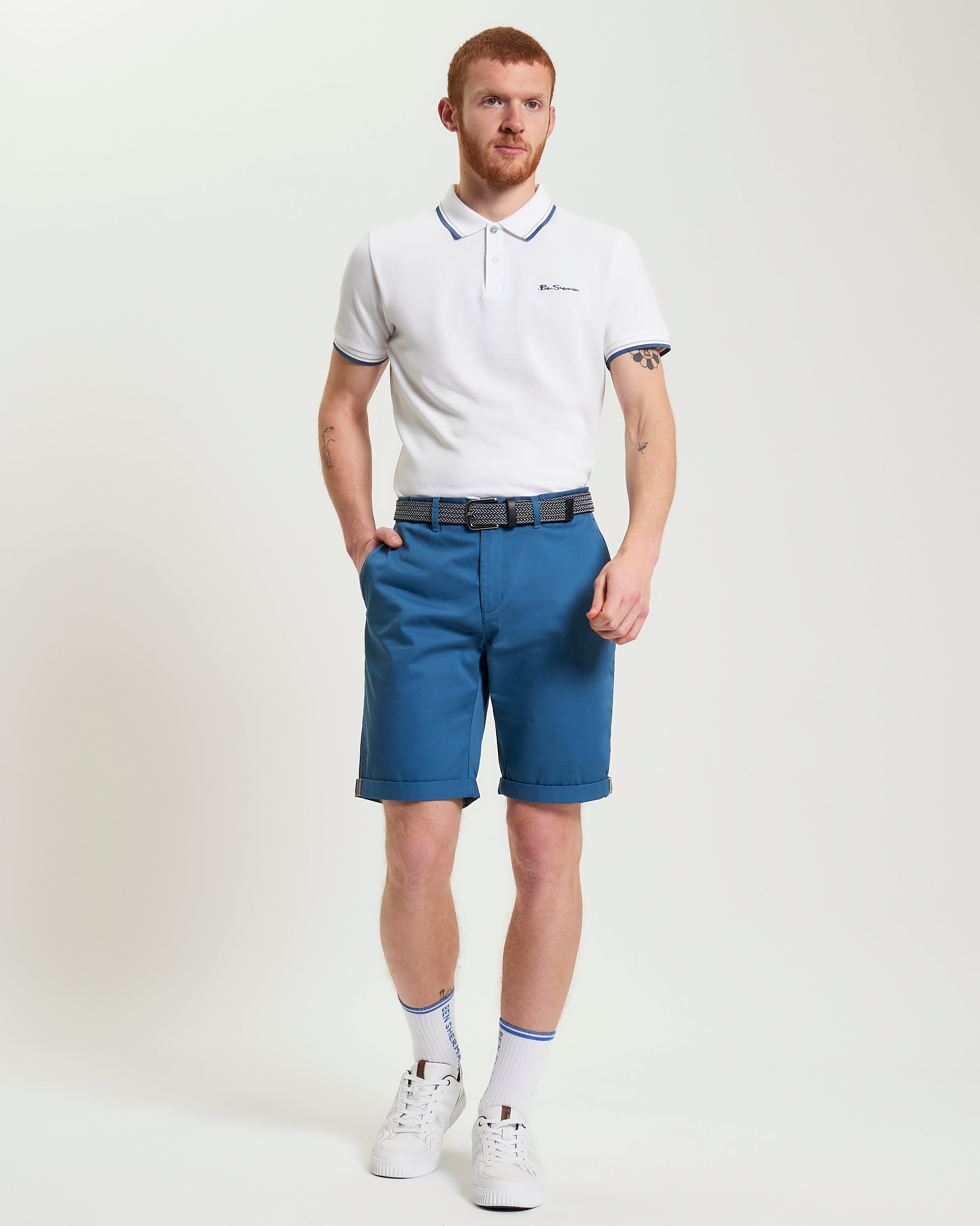 Signature Chino Short – blue chino shorts styled with a white polo for summer fashion.