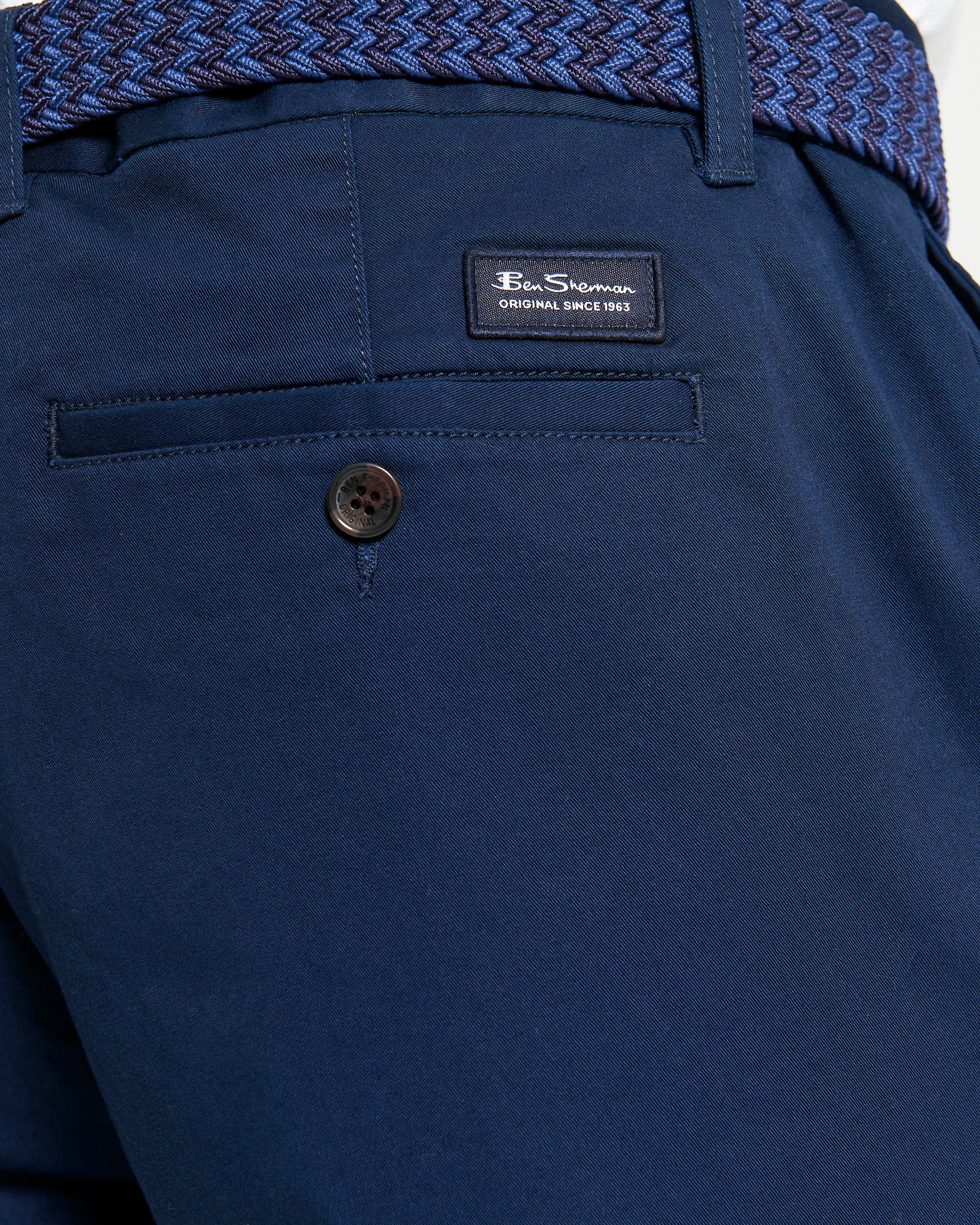 Signature Chino Short – navy blue with branded badge and strappy waistband detail.