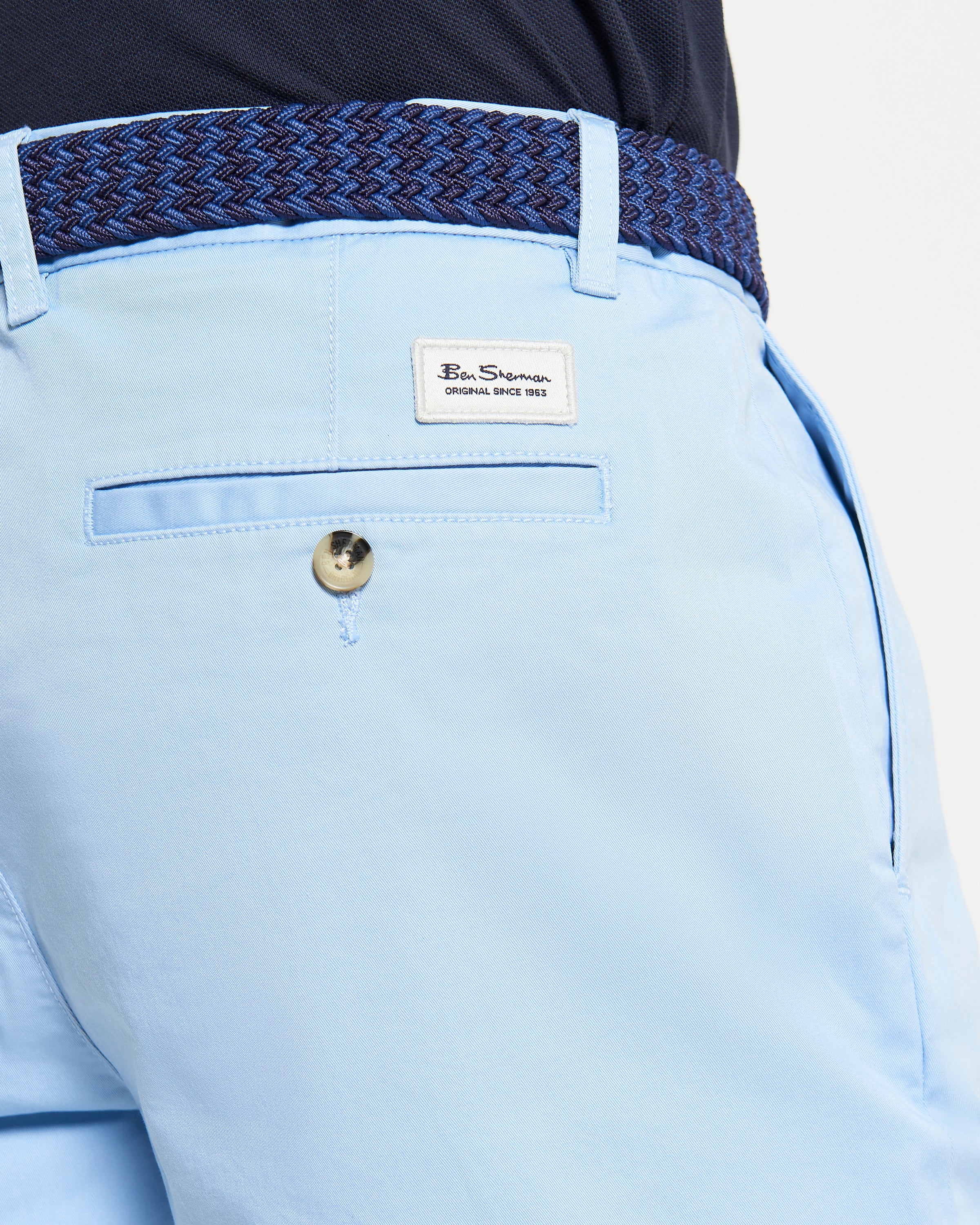 Back view of Signature Chino Short in light blue with branded label and woven belt detail.