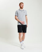 Man wearing Signature Chino Short and grey polo, showcasing summer style and comfort.