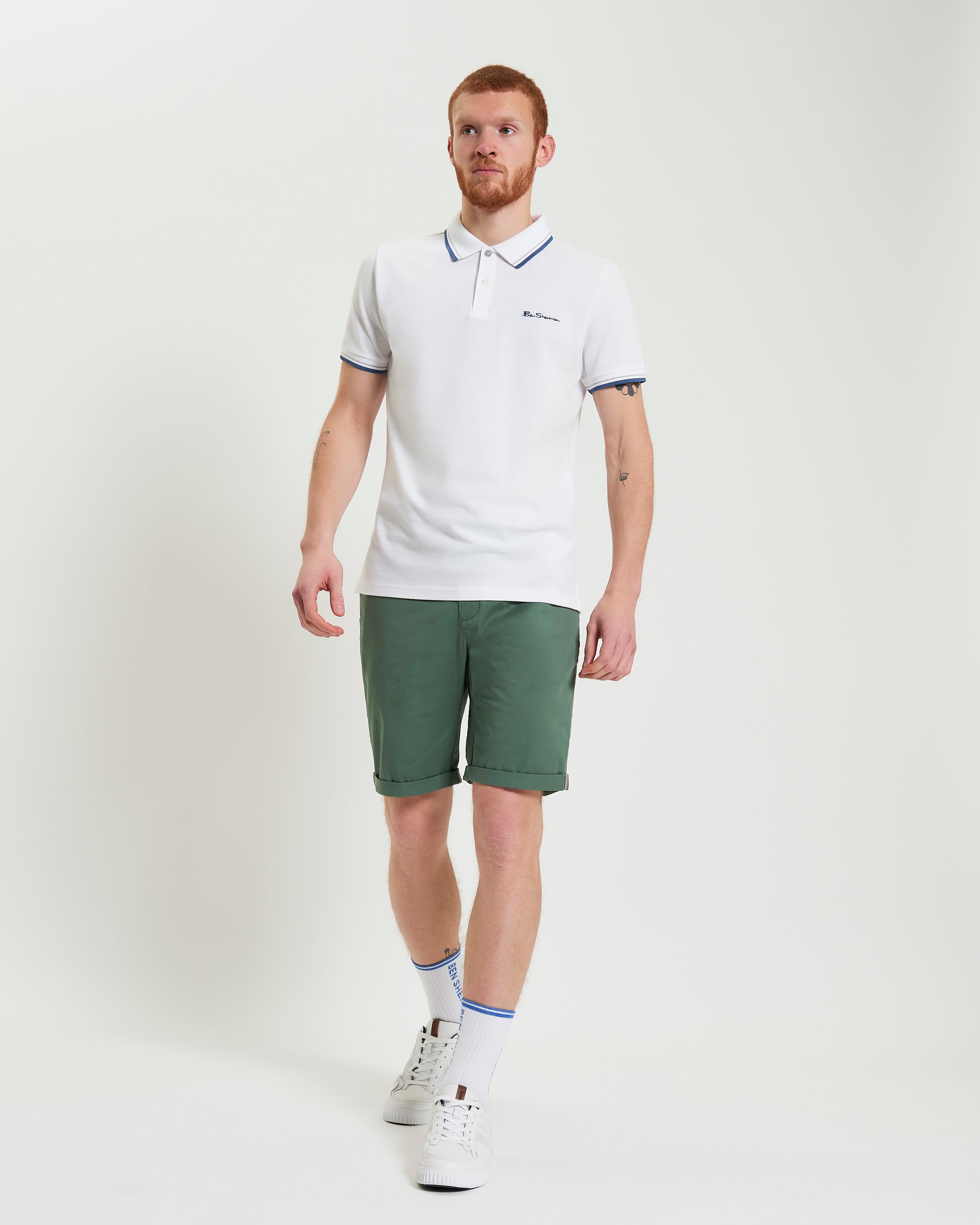 Man wearing Signature Chino Short in green with a white polo shirt, showcasing summer style and comfort.