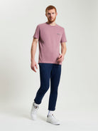 Signature Tee – pink crew neck t-shirt styled with navy pants and white sneakers, perfect for casual outings.