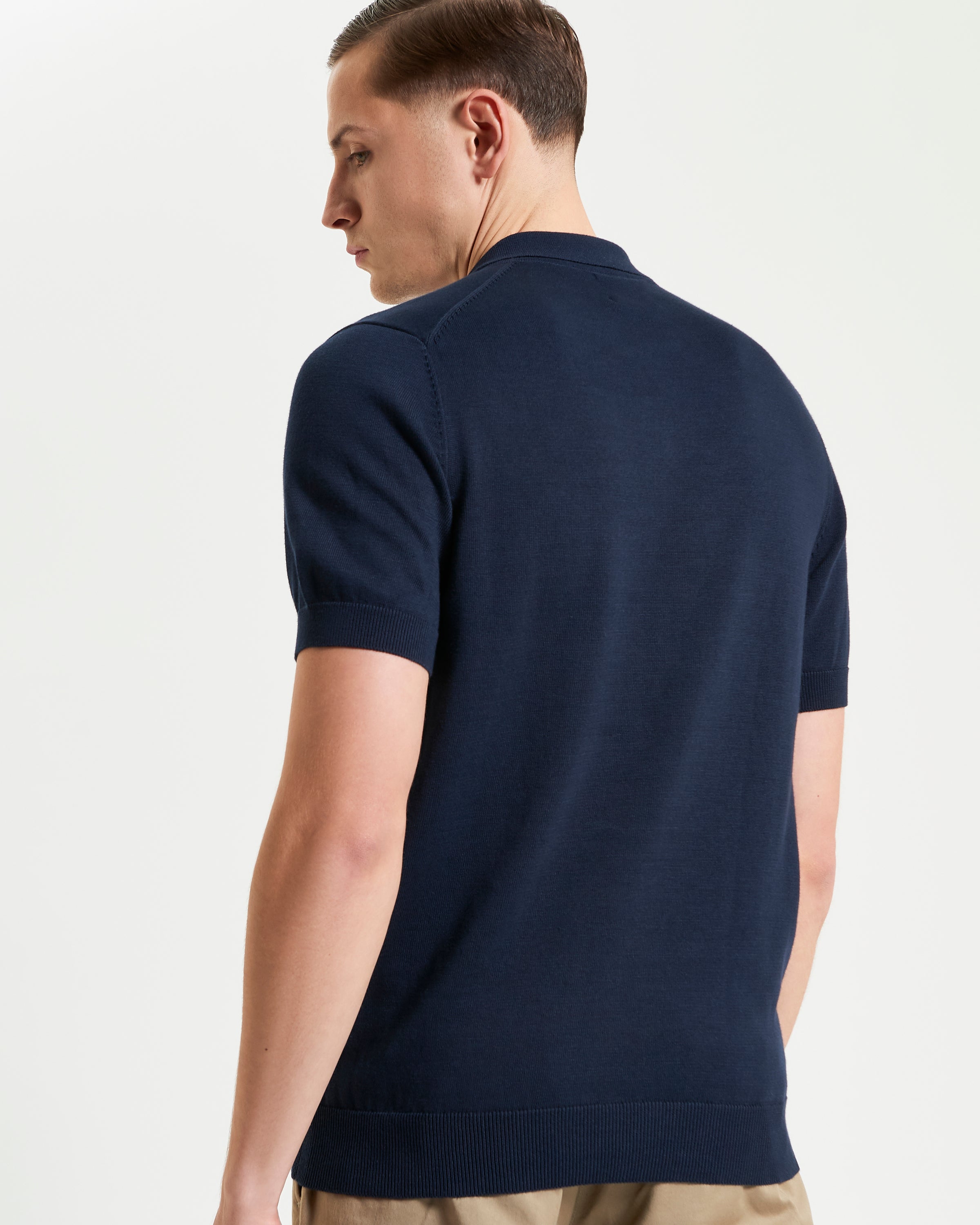 Signature Short Sleeve Polo – Navy blue short sleeve polo shirt featuring a ribbed collar and a sleek fit.