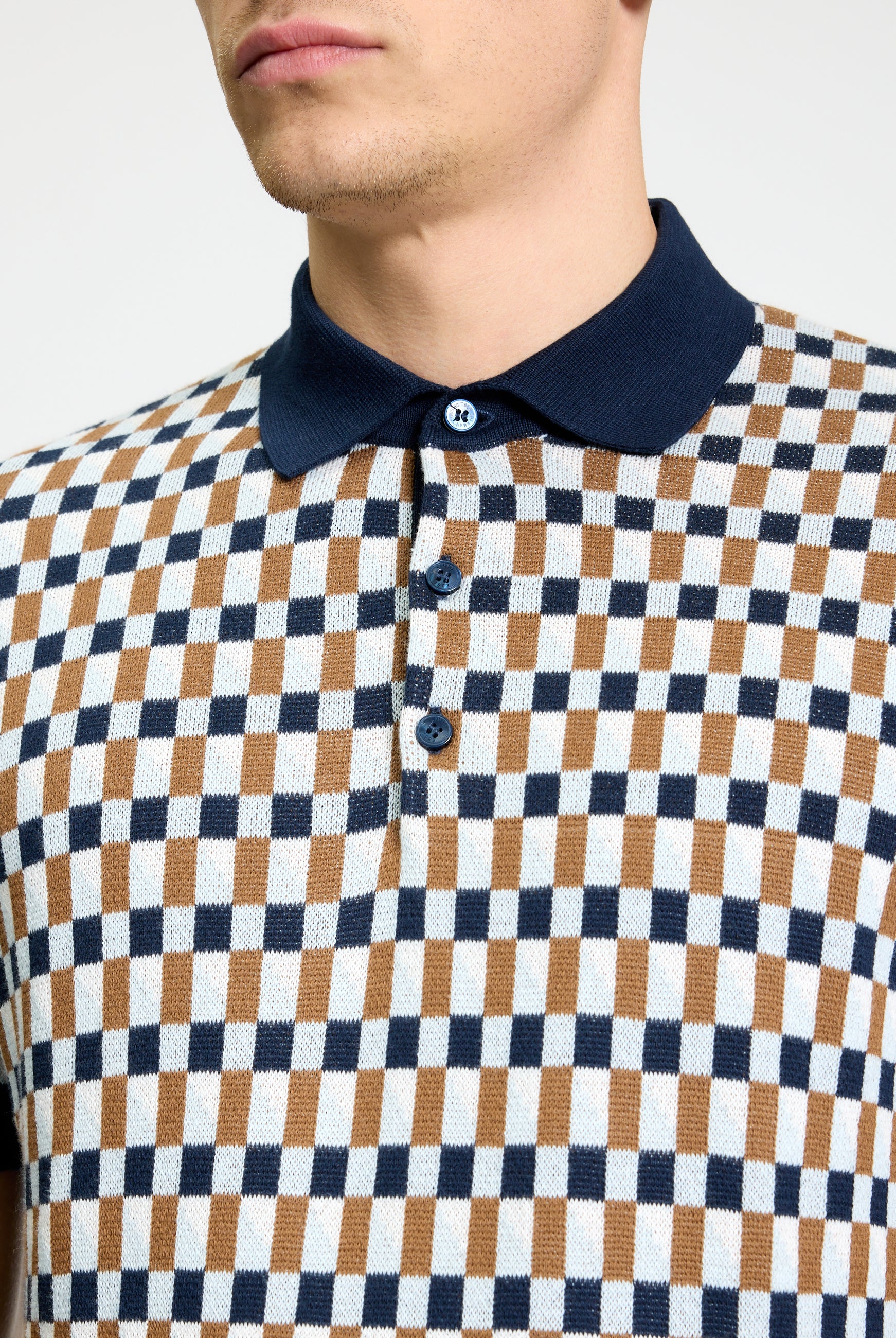 All Over Jacquard Polo – textured jacquard pattern polo shirt with navy collar and button details.