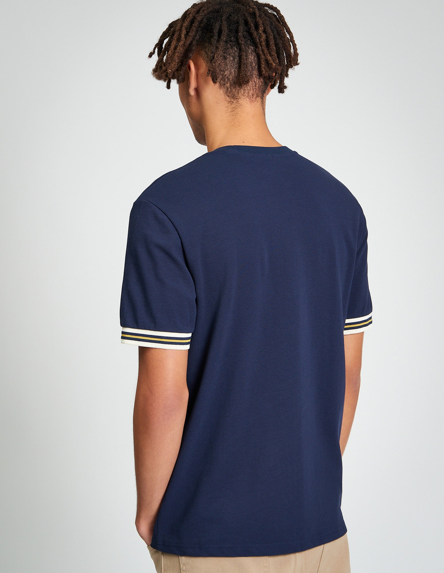 Pique Tipped Tee β back view showcasing navy color and contrast striped cuffs on a relaxed-fit style.