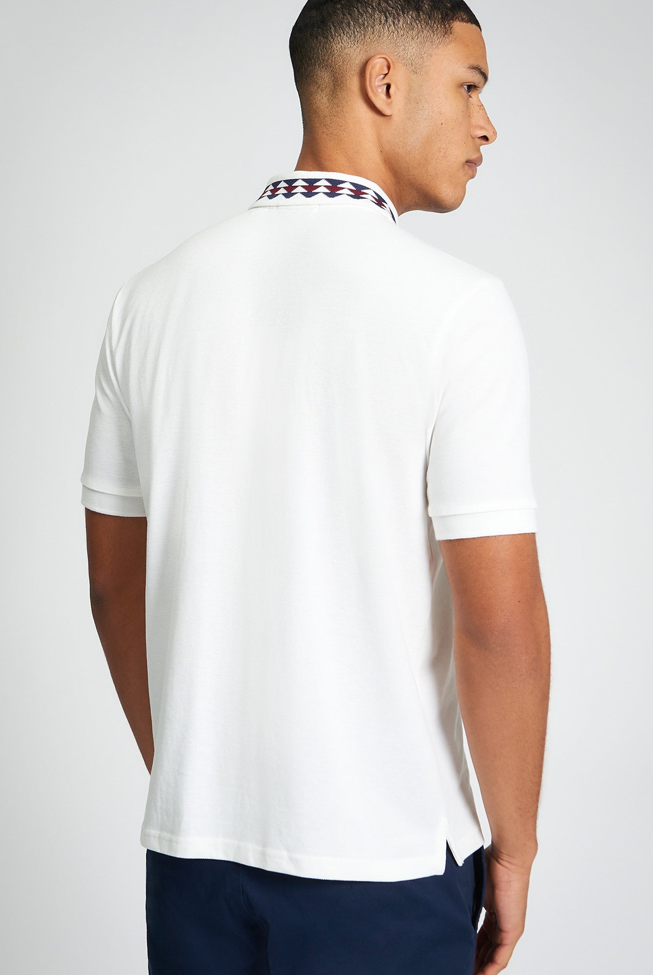 Collar Interest Polo β Back view showcasing patterned collar detail and regular fit in white cotton.