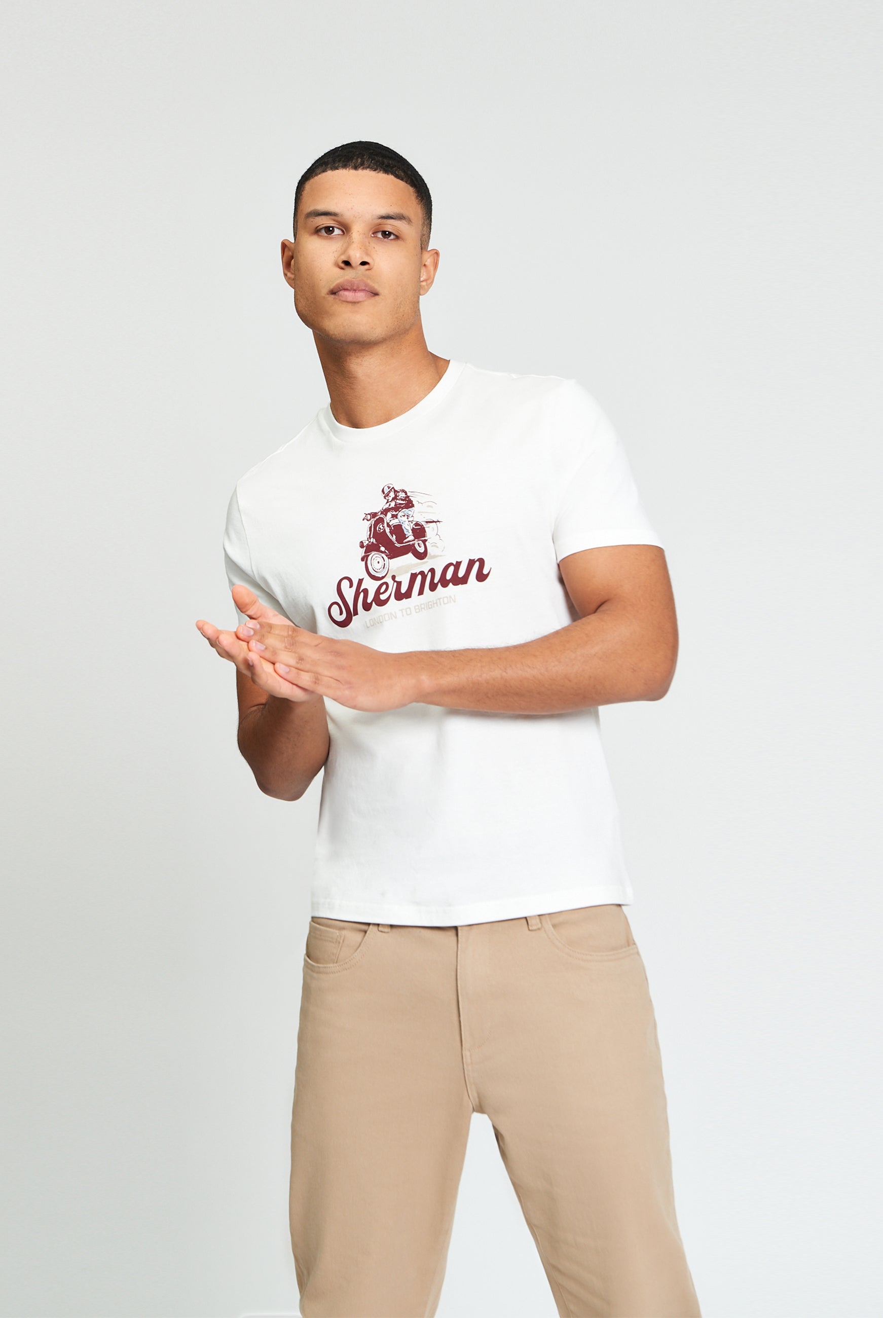 Race Day Tee β white shirt with bold graphic print, modeled by a man in casual style, showcasing comfort and design.