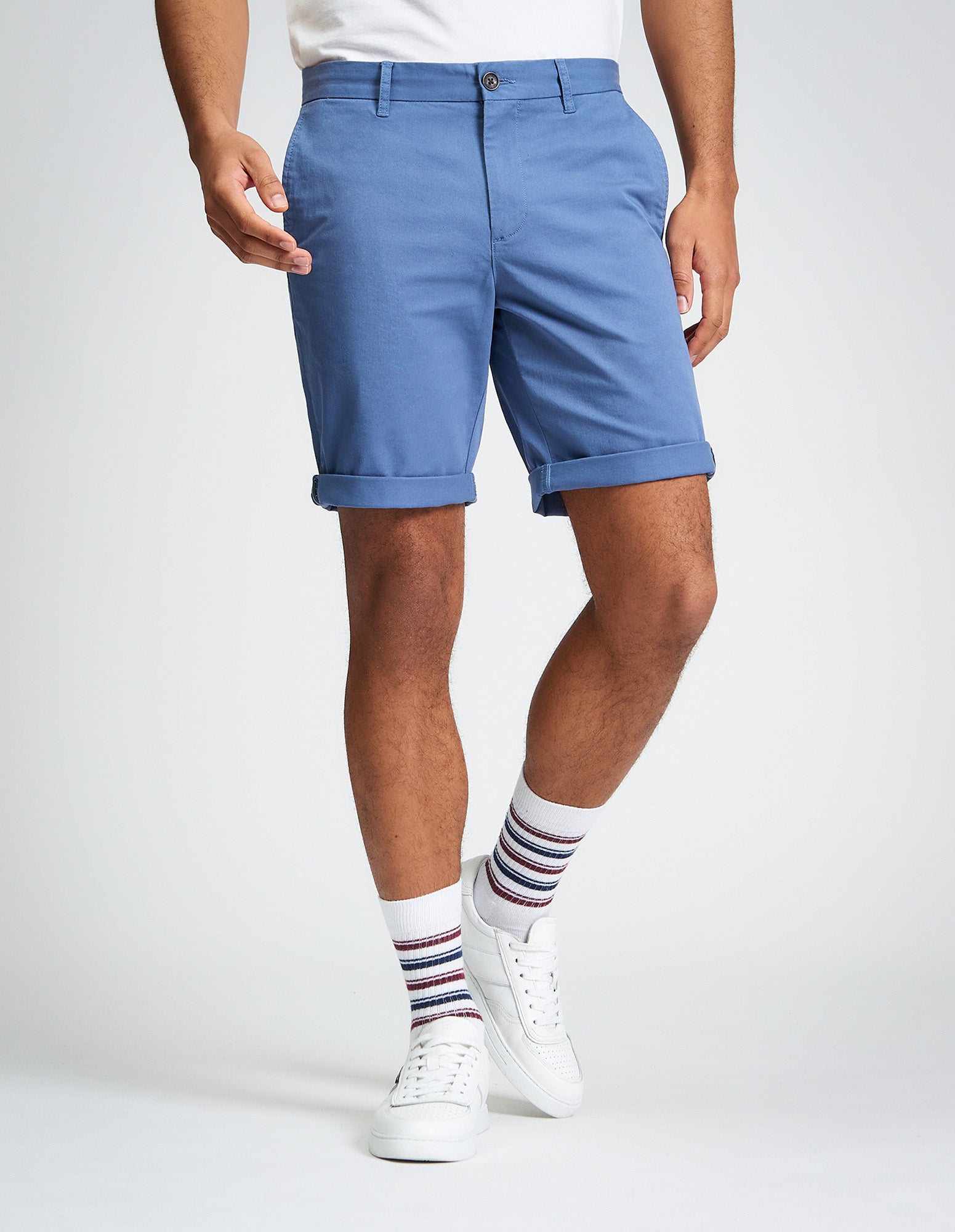 Signature Chino Short β Blue shorts with rolled cuffs, styled with a white t-shirt and patterned socks.