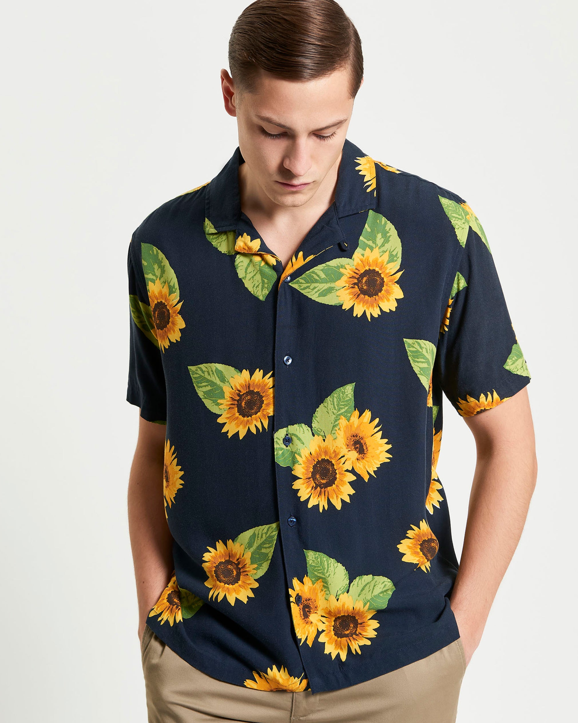 Man wearing Ben Sherman navy blue Sunflower shirt with sunflower pattern on a white background