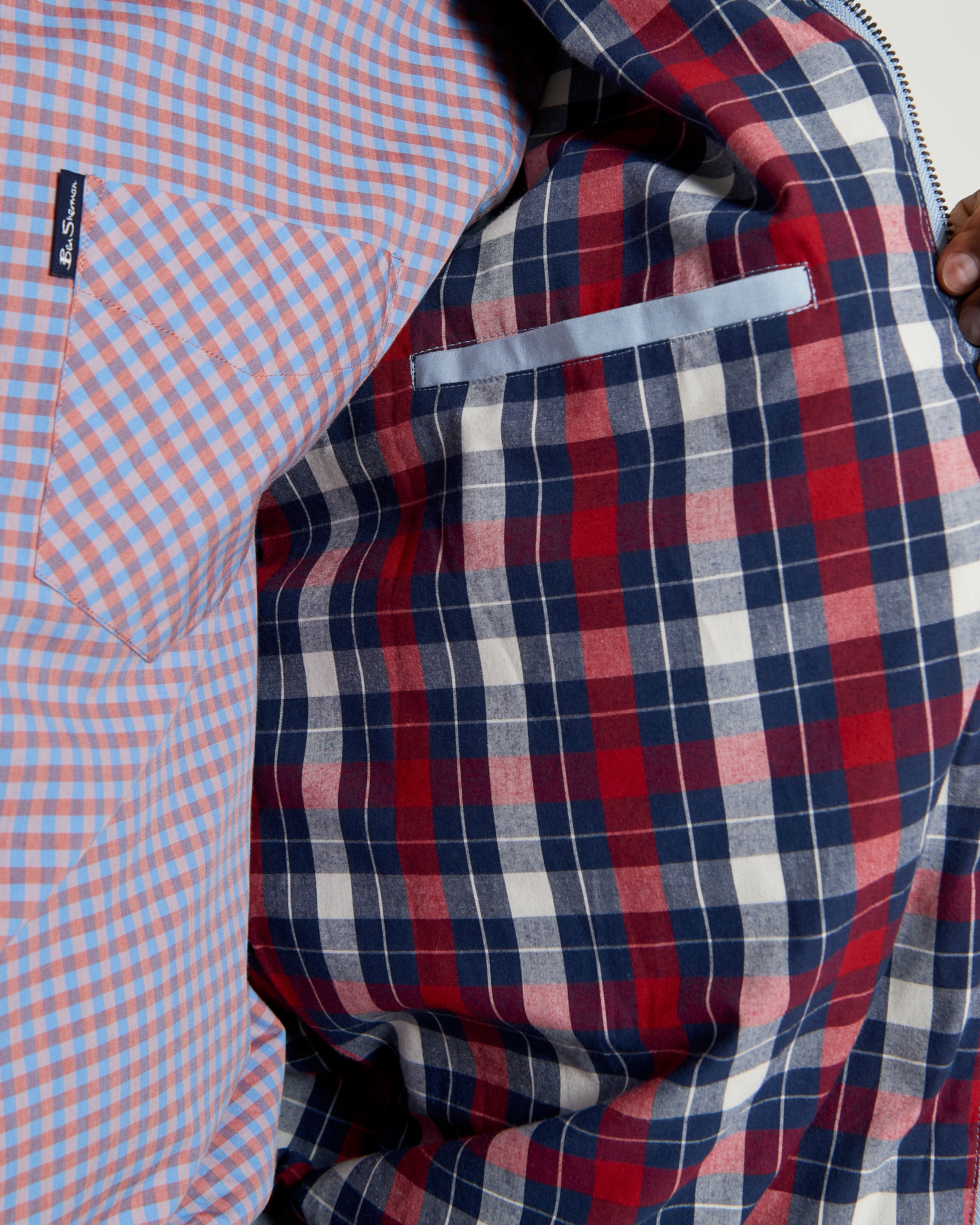 Interior view of the Signature Harrington Jacket showcasing house check lining in red and navy with a contrasting pocket.