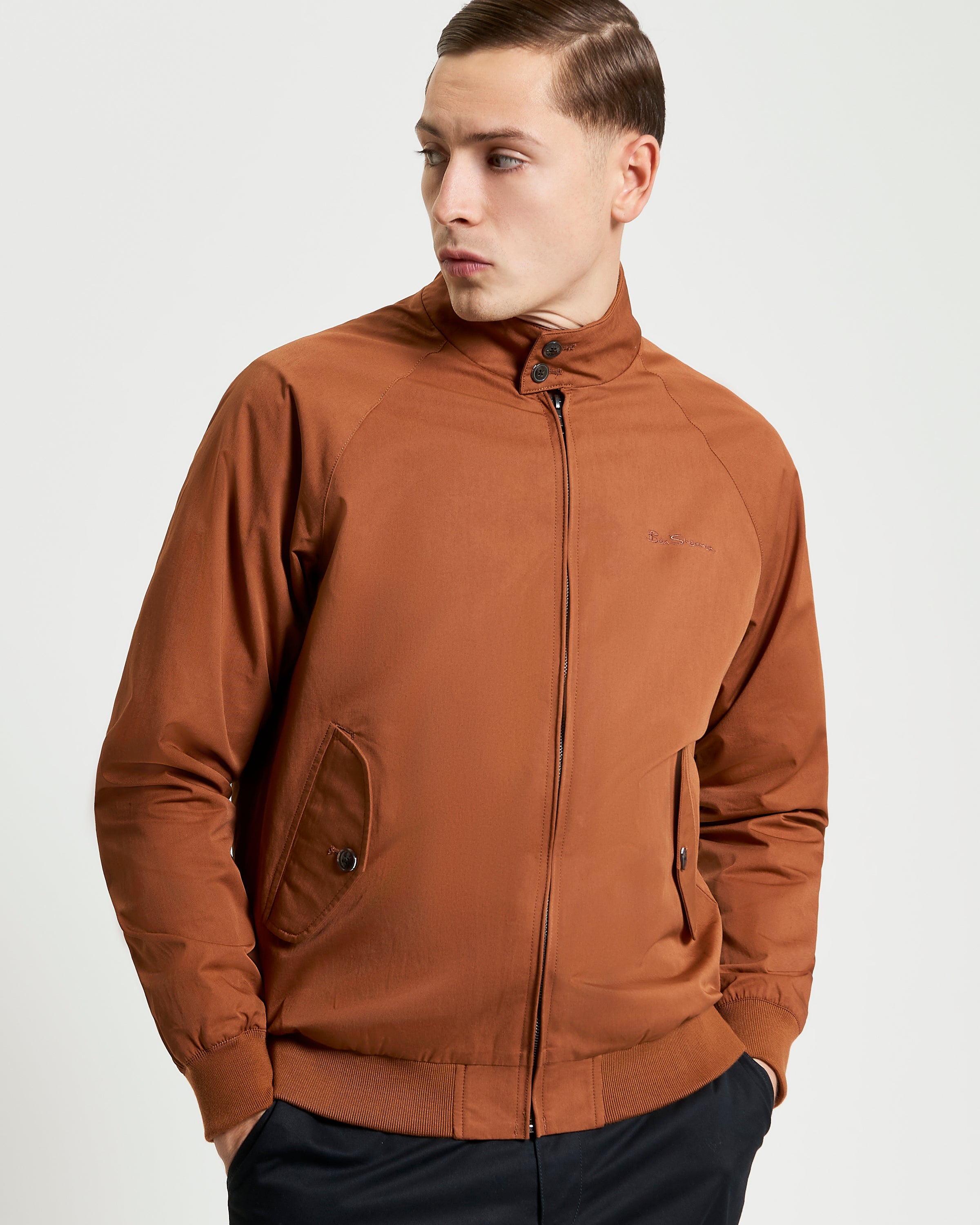 Model wearing the Signature Harrington Jacket in brown, featuring a zip closure and stand collar design.