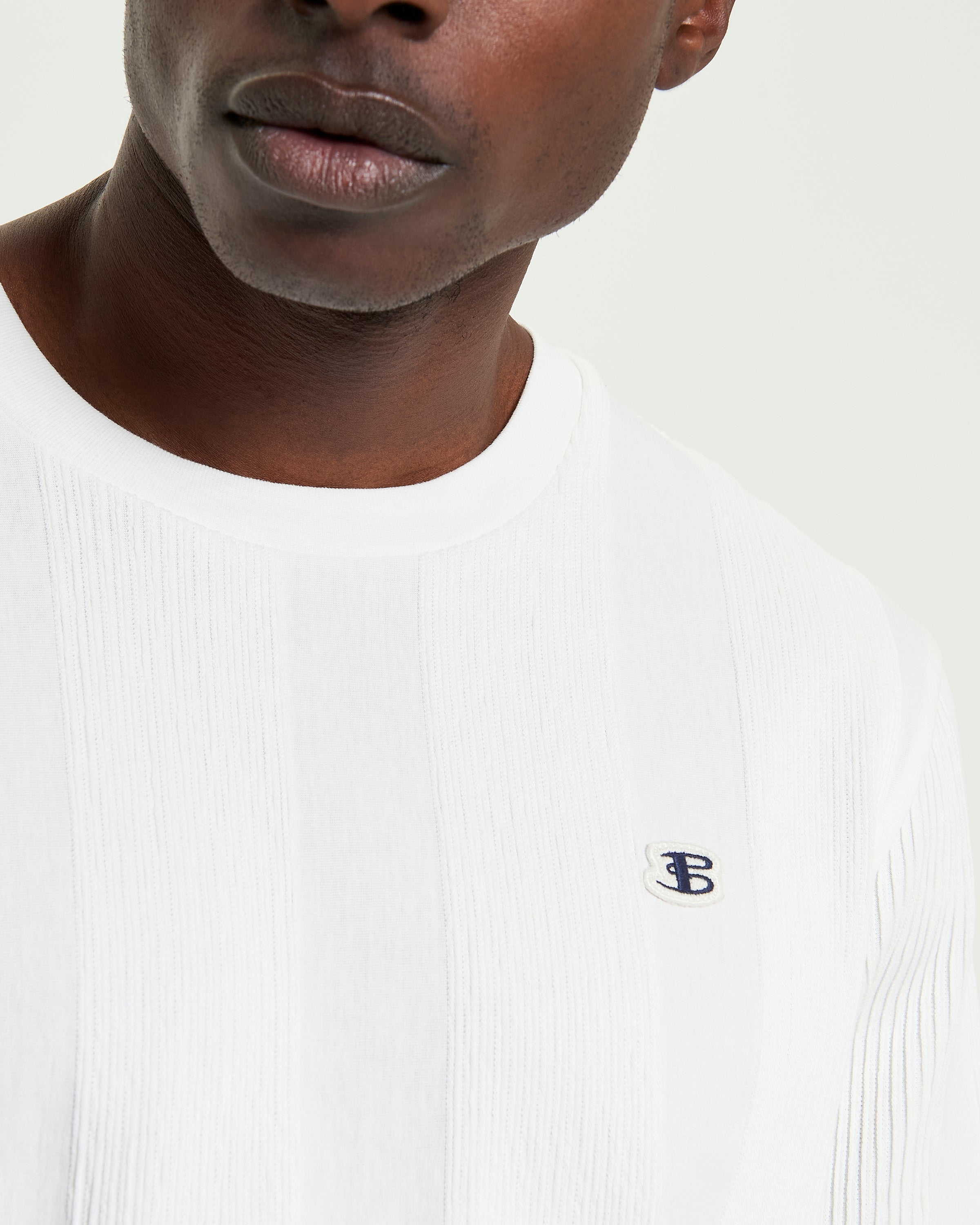 Textured Vertical Stripe Tee – white – relaxed-fit with vertical stripe design and 'B' badge branding on the chest.