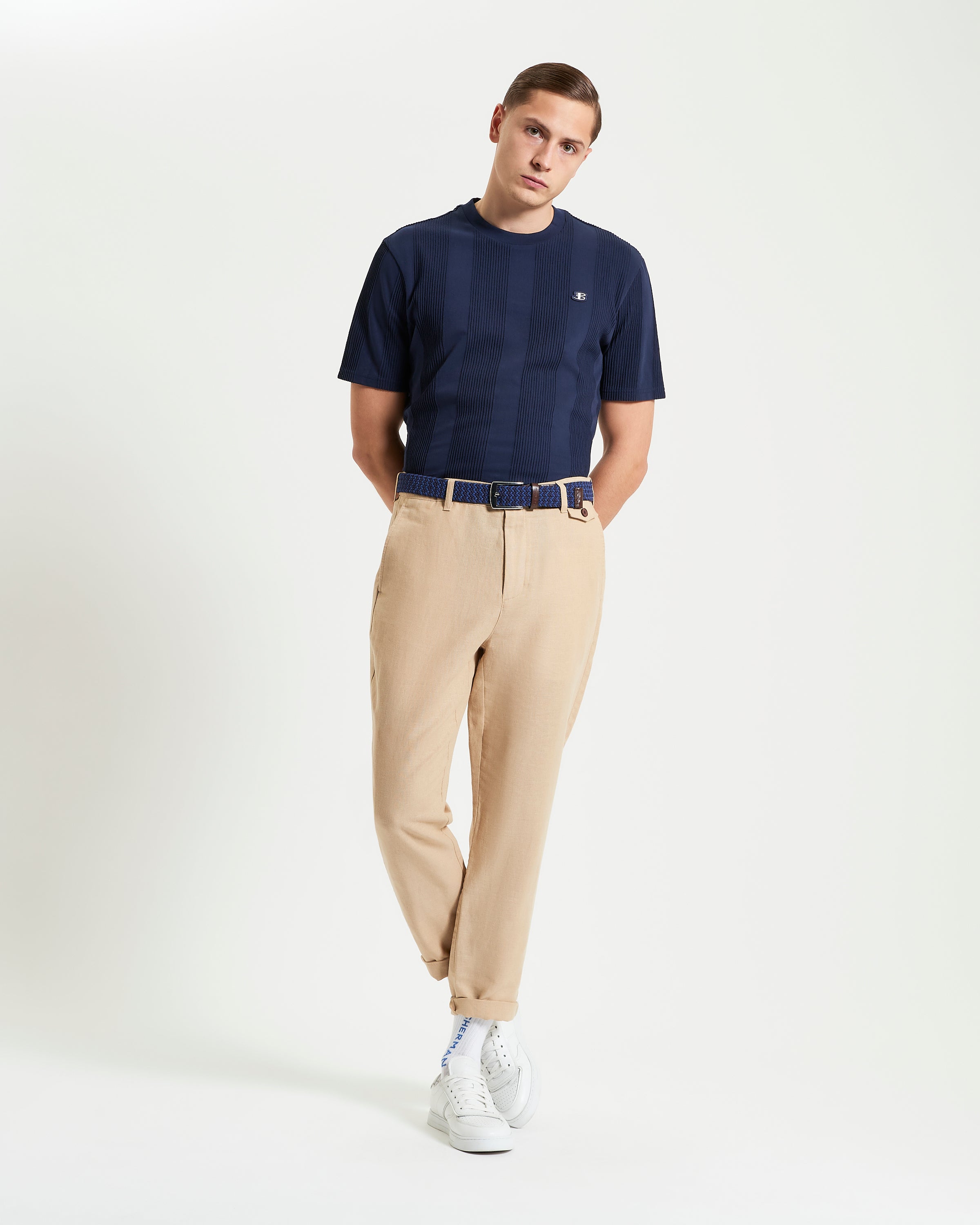 Textured Vertical Stripe Tee worn with beige trousers and white sneakers, showcasing a relaxed-fit modern style.