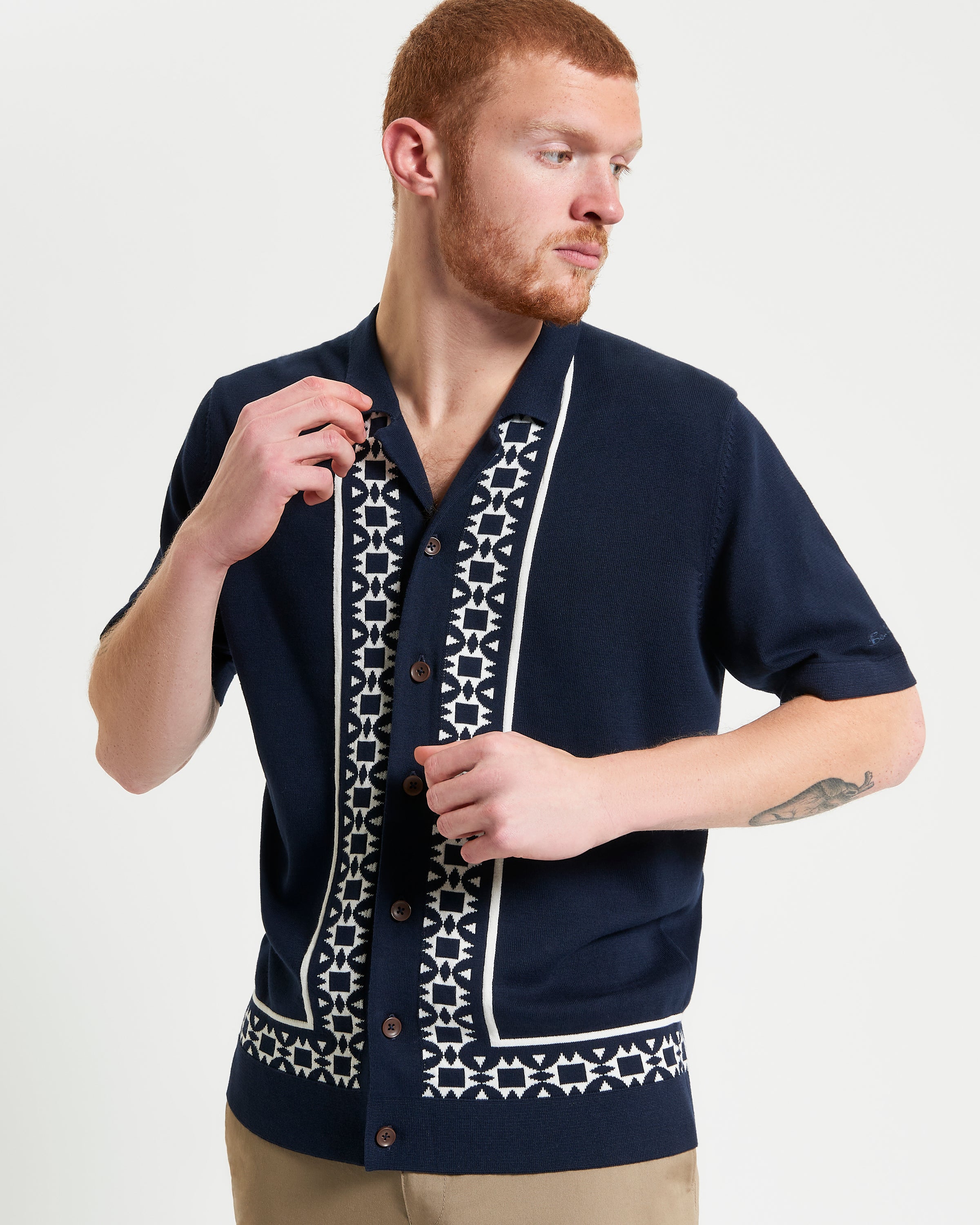 Floral Border Resort Shirt – navy short-sleeve knitted shirt with geo border print and button-through placket.