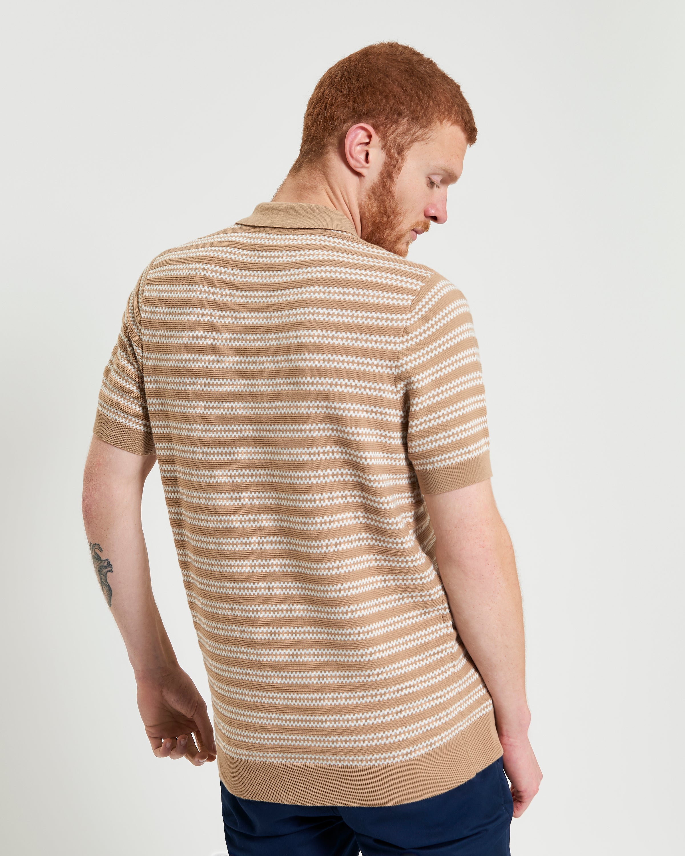 Jacquard Stripe Polo – beige and white striped knit polo showcasing unique jacquard pattern and short sleeves.