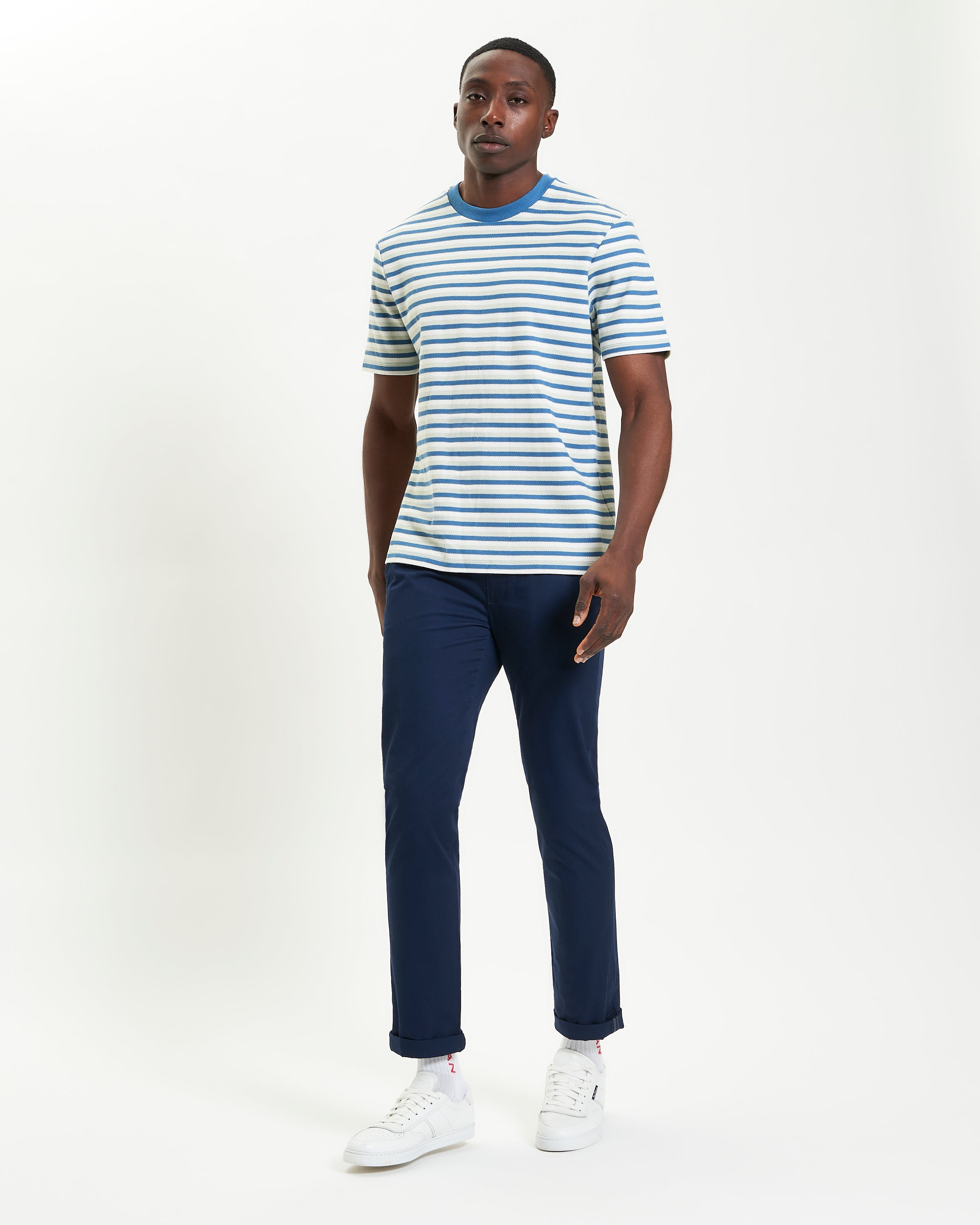 Honeycomb Stripe Tee – striped crew neck shirt worn with navy pants and white shoes, showing relaxed fit and style.