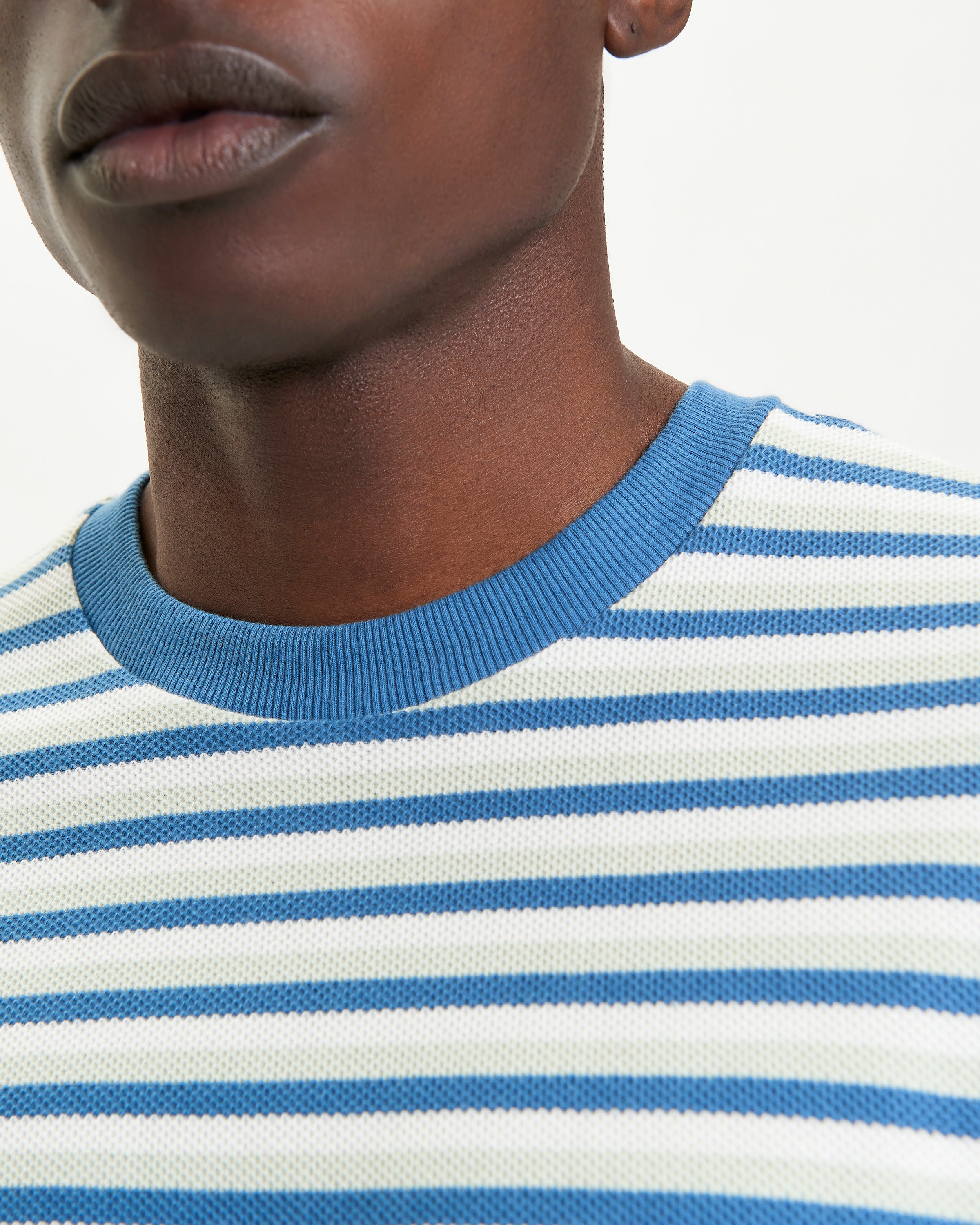 Honeycomb Stripe Tee – blue and white striped crew neck shirt detail showing texture and relaxed fit.