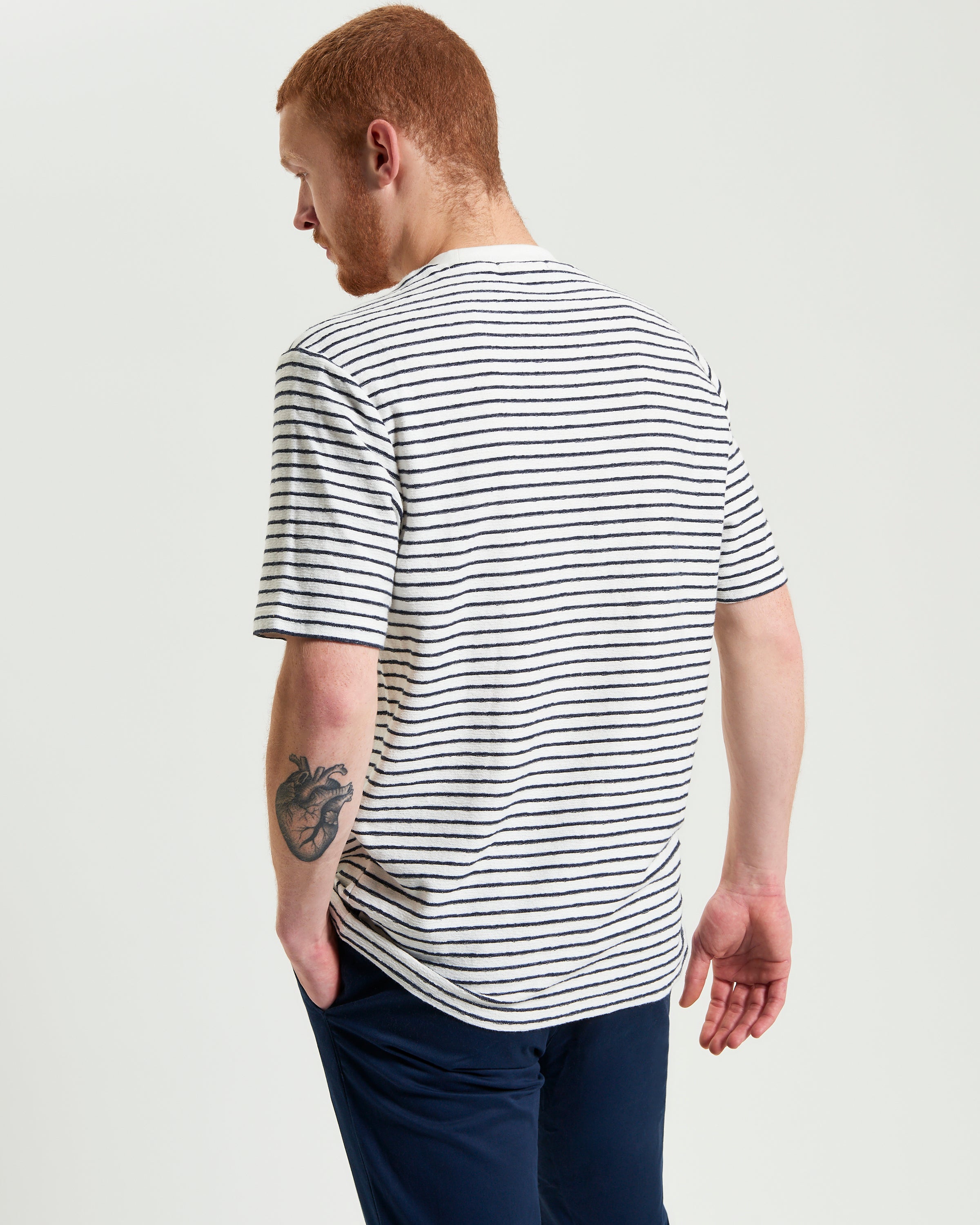 Textured Stripe Tee – striped design with crew neck, showing relaxed fit from the back, ideal for everyday wear.