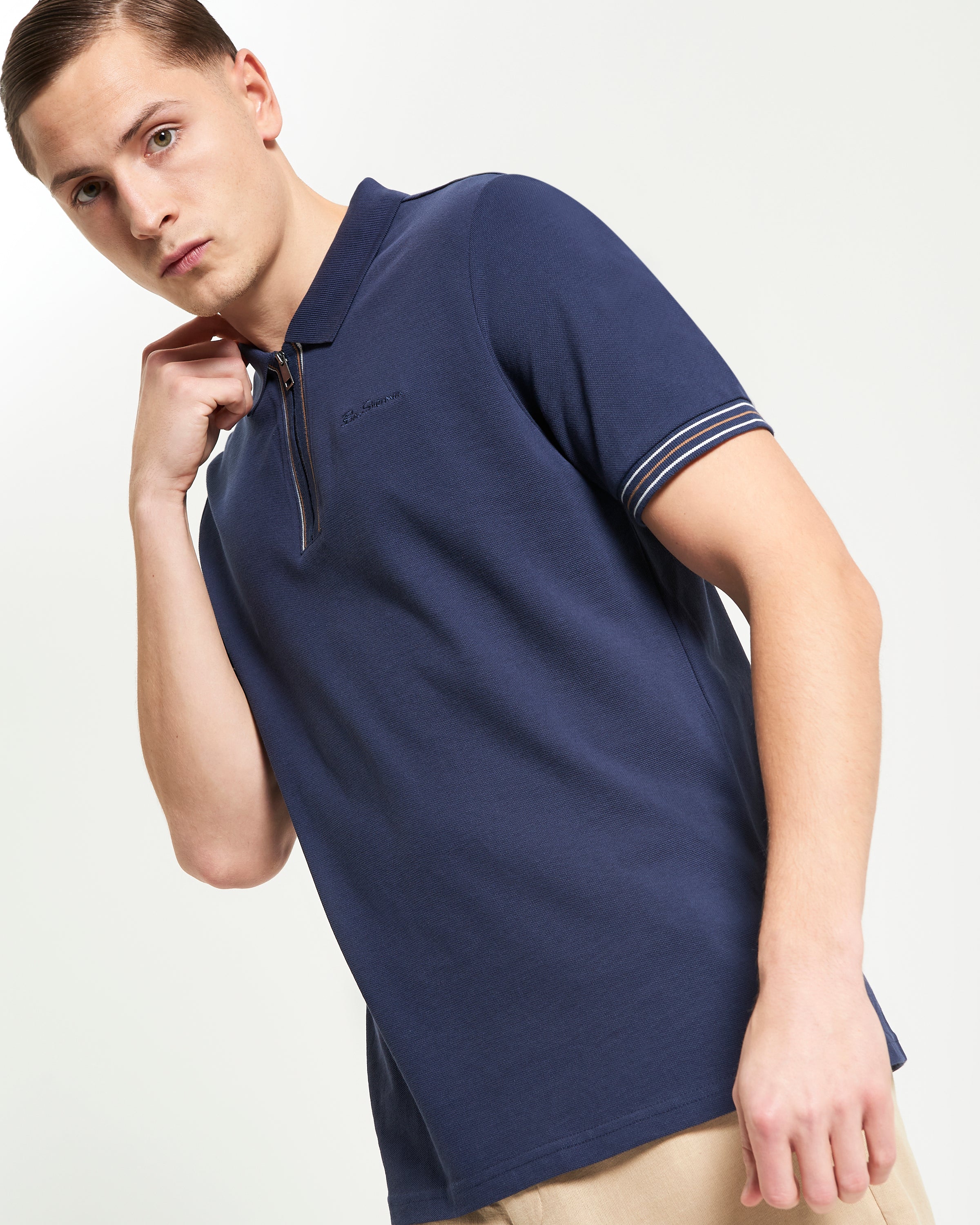 Placket Interest Polo – relaxed fit pique polo with silver zip fastening and striped cuff detailing.
