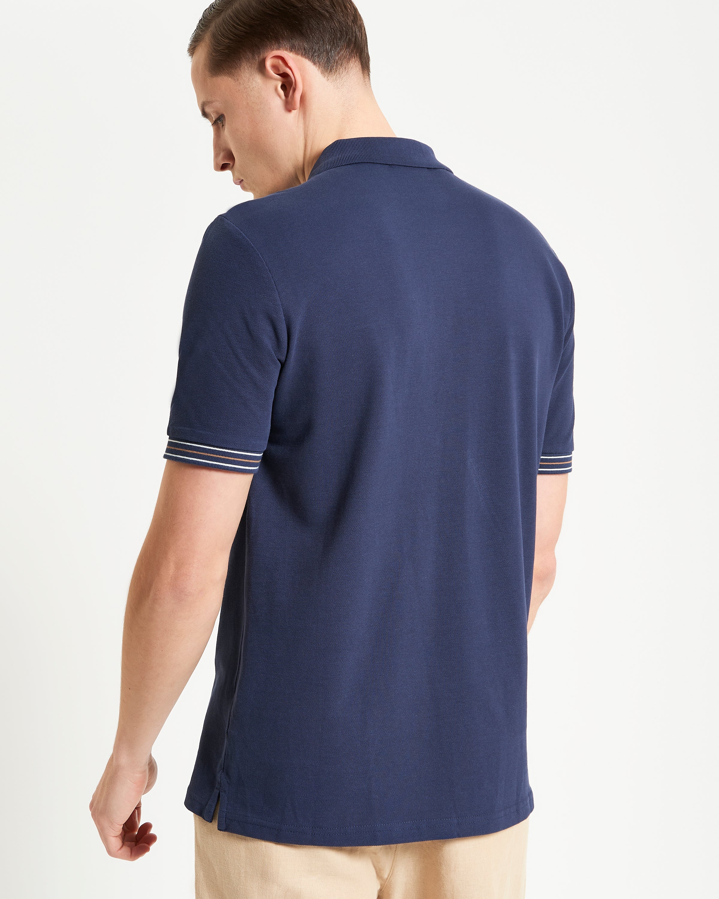 Placket Interest Polo – back view showing relaxed fit and striped cuff detailing.