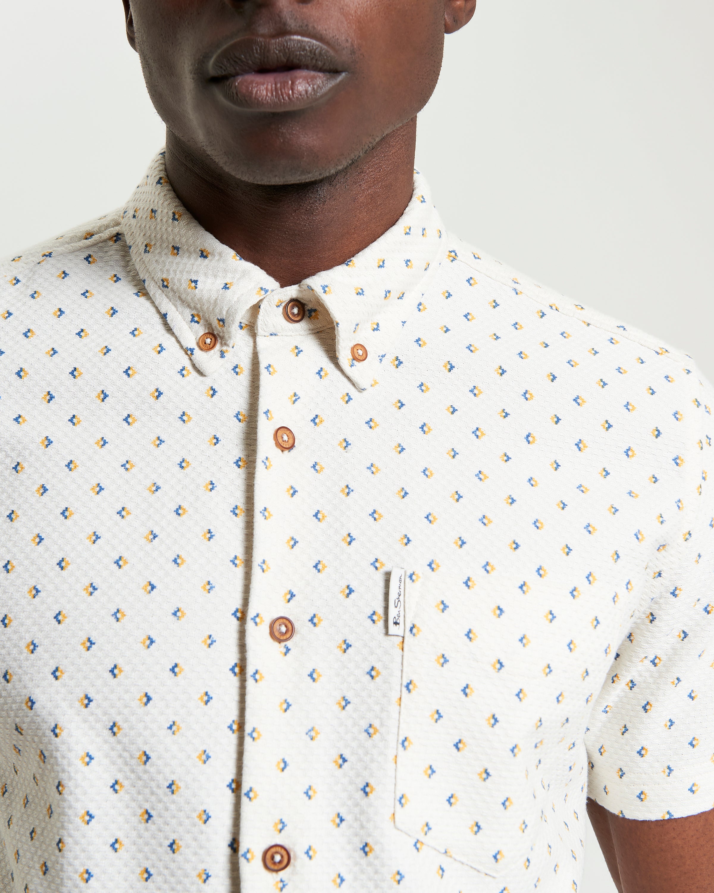 Split Geo Print short-sleeve shirt featuring a two-finger button-down collar and eye-catching pattern.