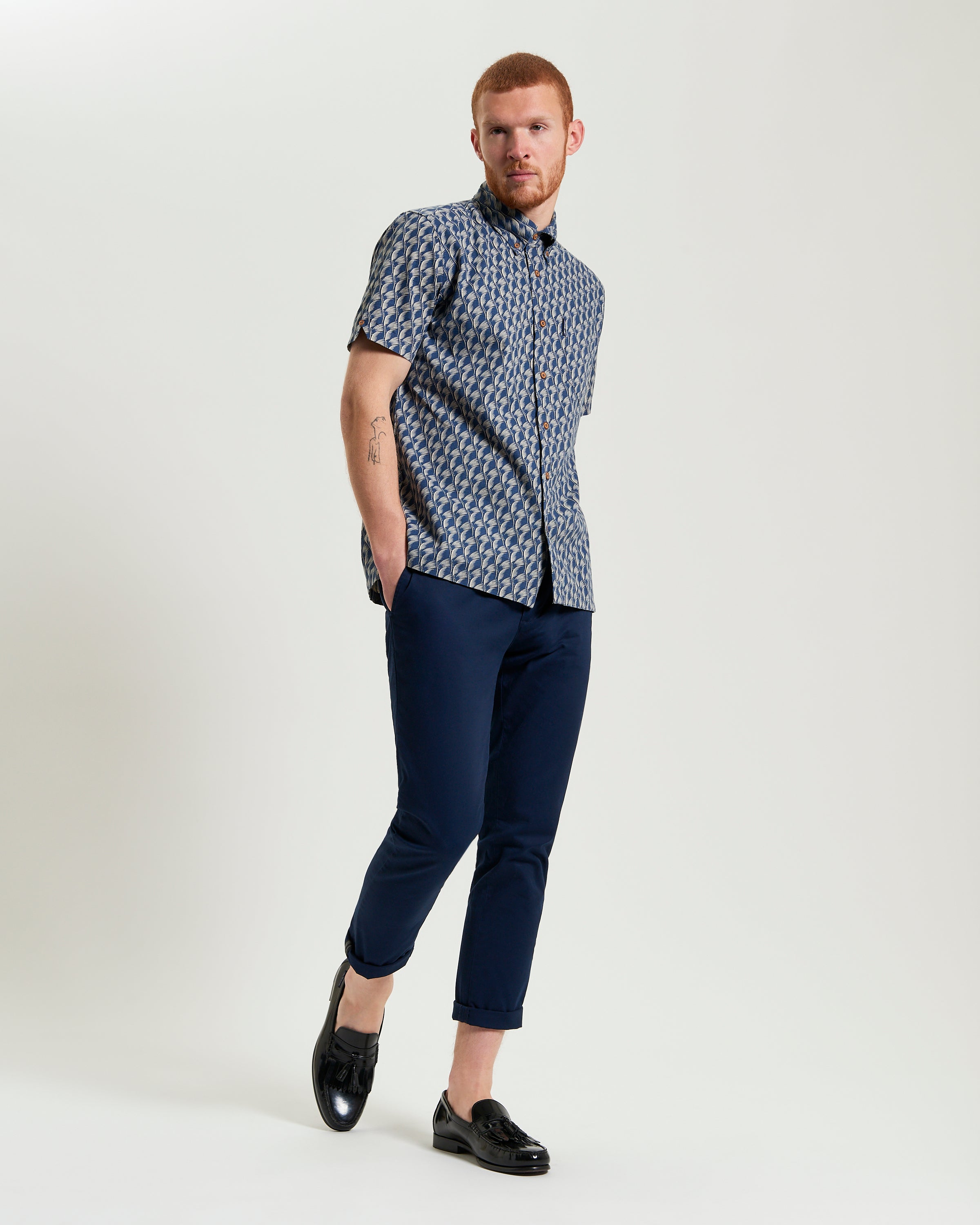 Block Leaf Print Shirt on a model styled with navy pants and black shoes, showcasing a nature-inspired pattern.