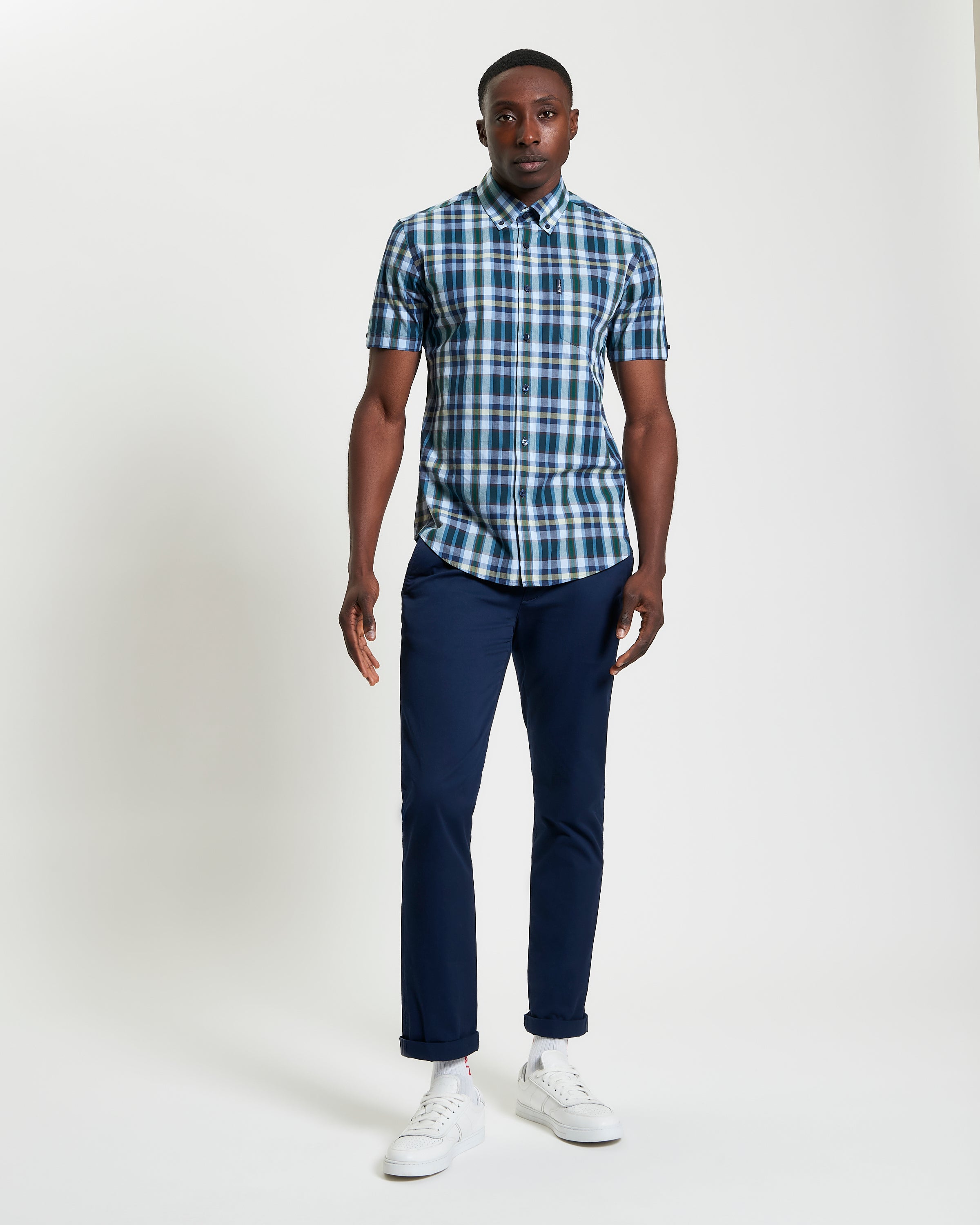 Irregular Check – blue and green short sleeve shirt worn with navy pants and white sneakers.