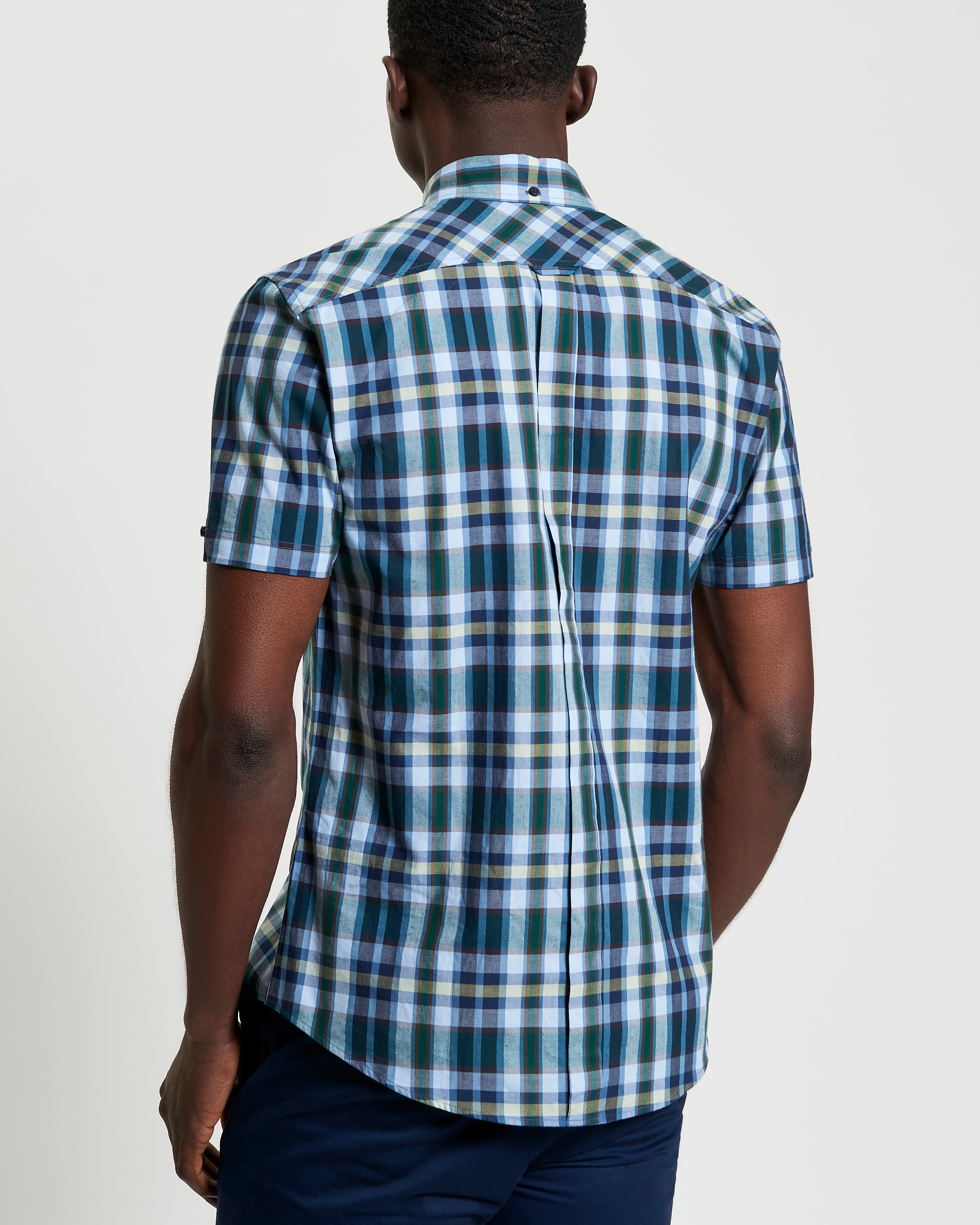Irregular Check shirt – back view showcasing modern check pattern and curved hem design.
