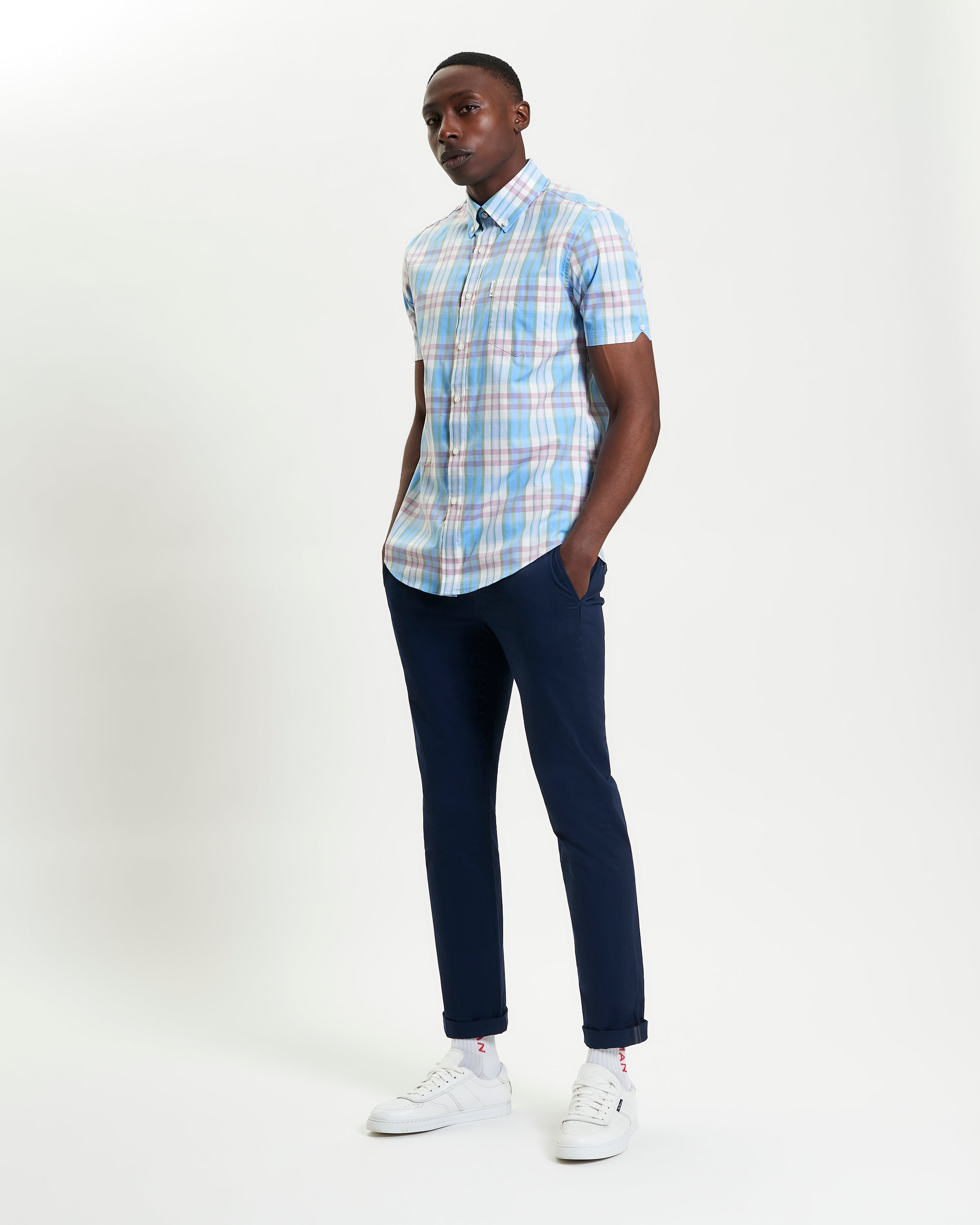 Irregular Check shirt in blue and pink plaid worn with navy pants for a stylish casual look.
