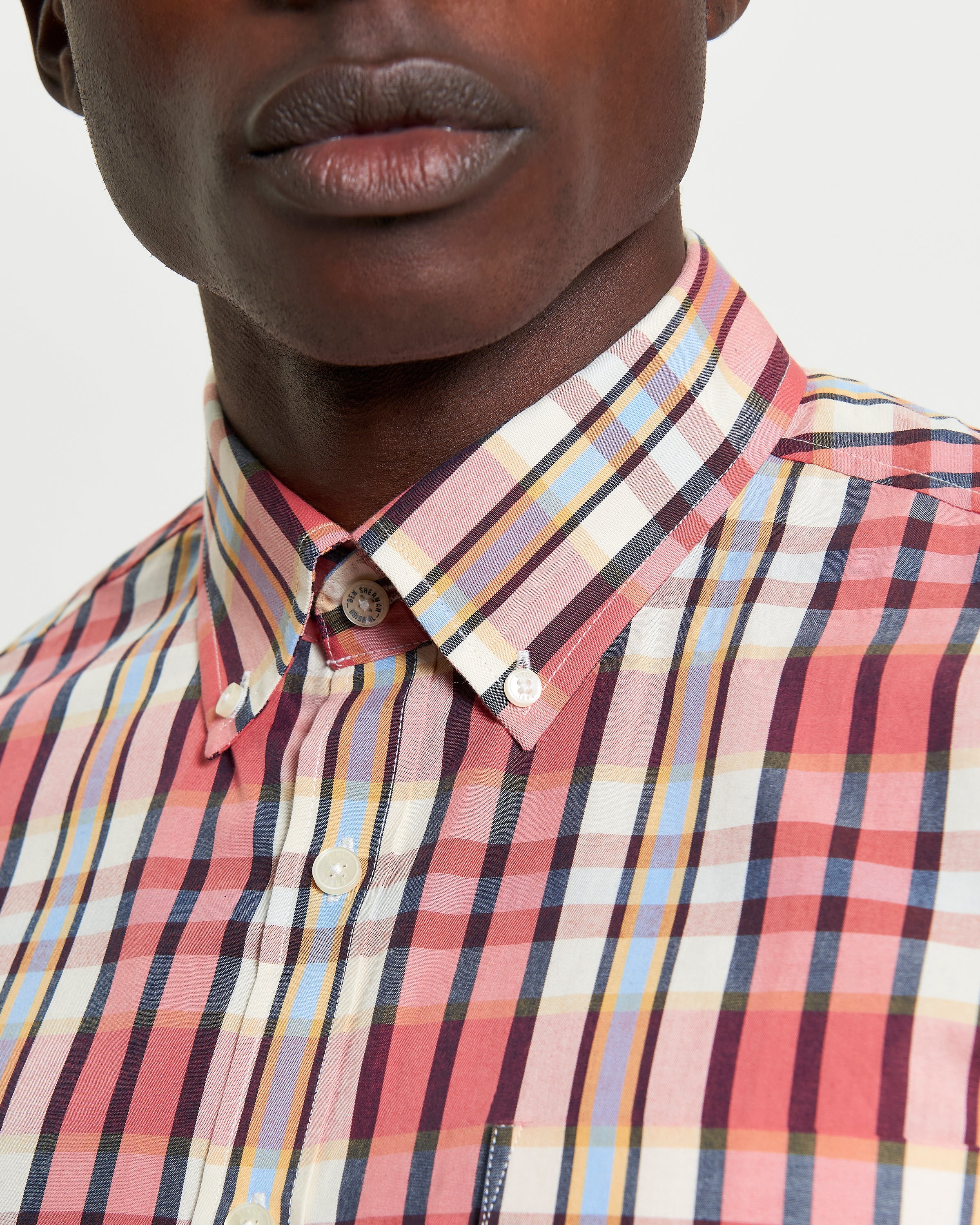 Irregular Check shirt – organic cotton with curved hem and button-down collar.