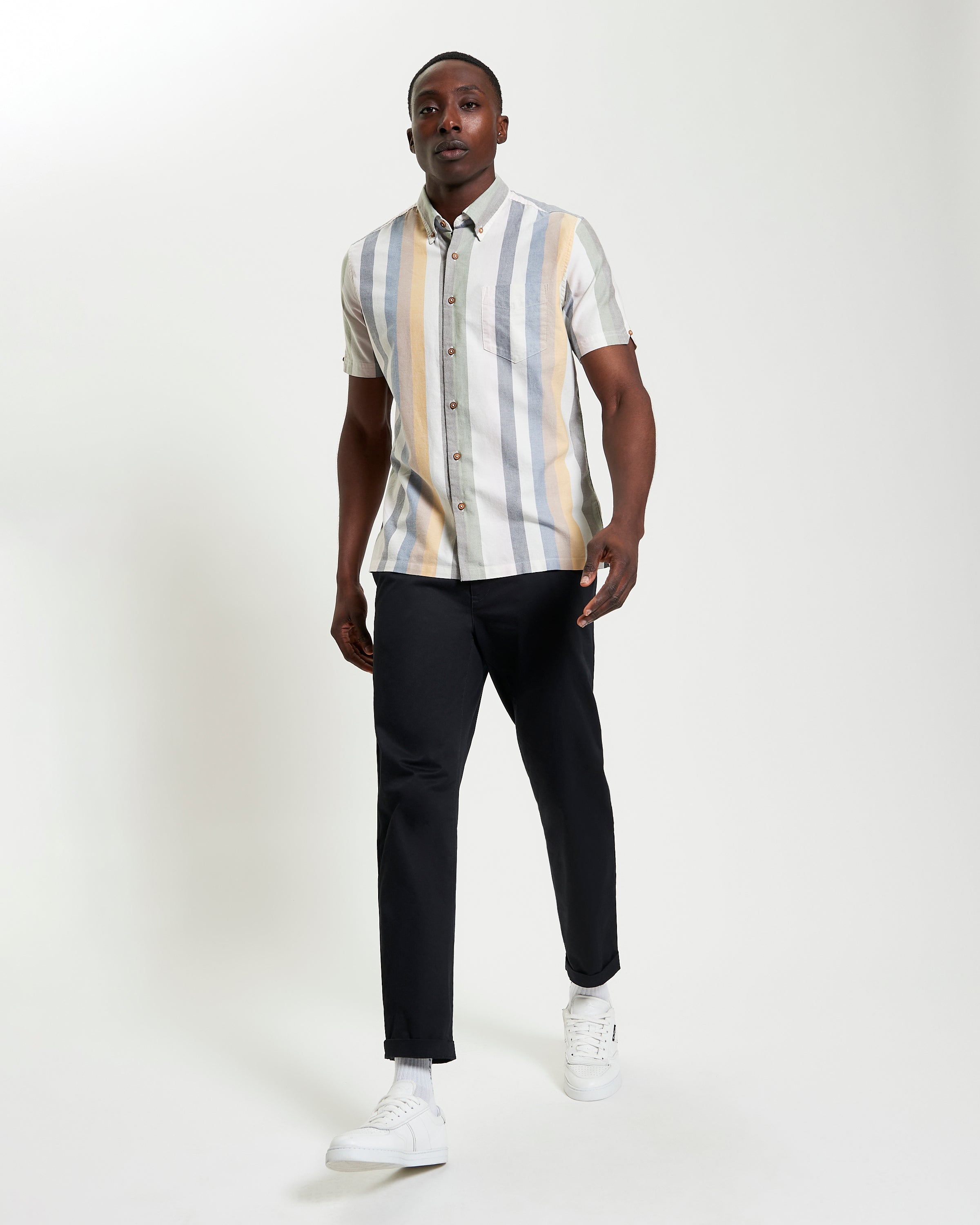 Candy Stripe shirt modeled by a man, featuring short sleeves and a straight hem, perfect for warm weather style.
