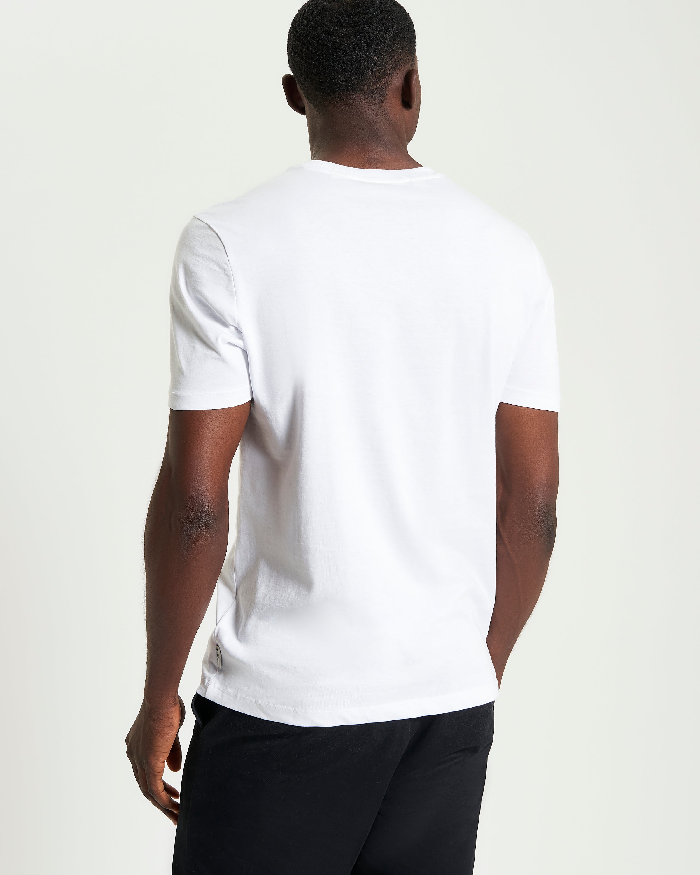 Core Striped Tee – back view of a man wearing a white organic cotton t-shirt with short sleeves.
