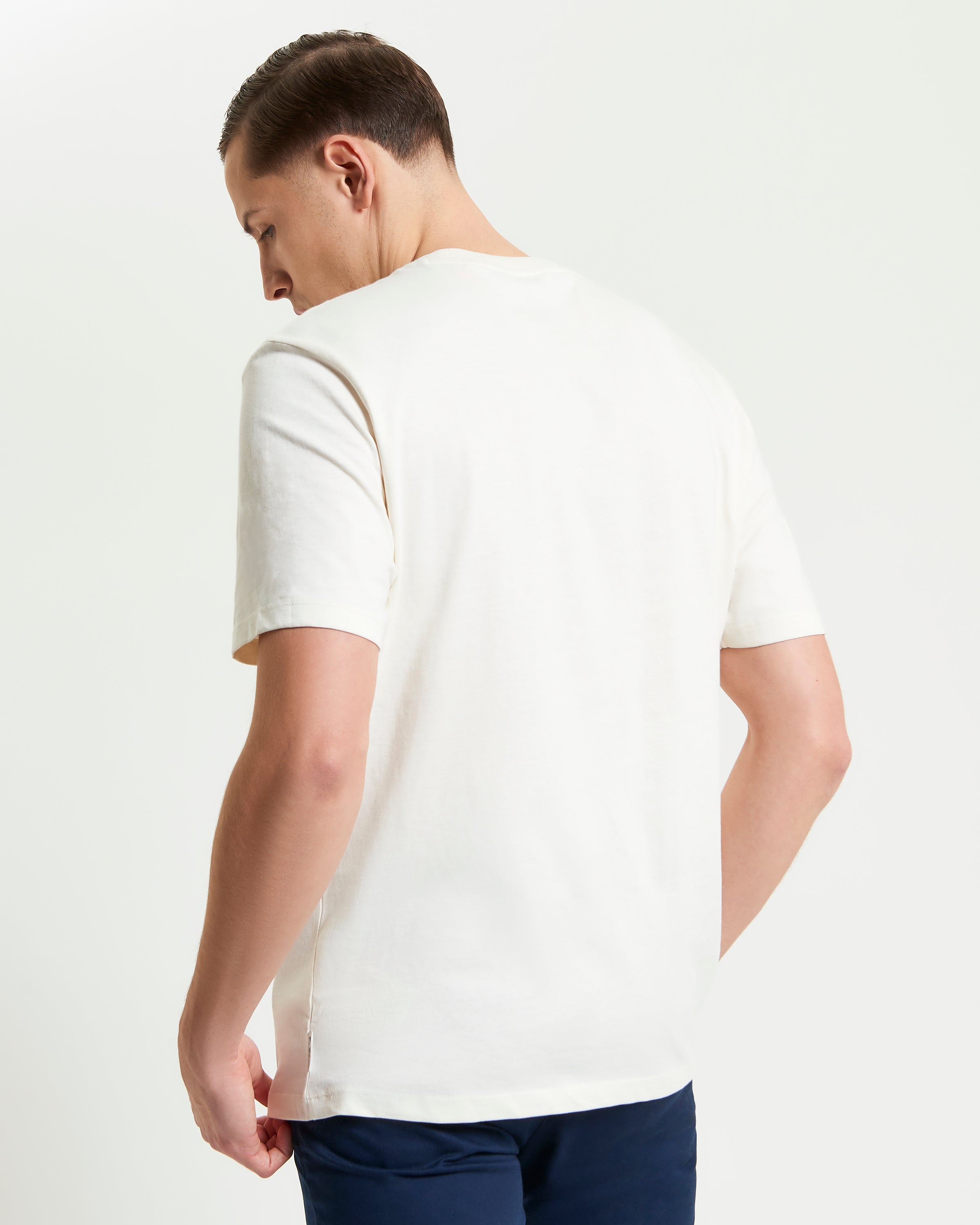 Back view of a man wearing the Rascal Rider Target Tee in soft organic cotton.